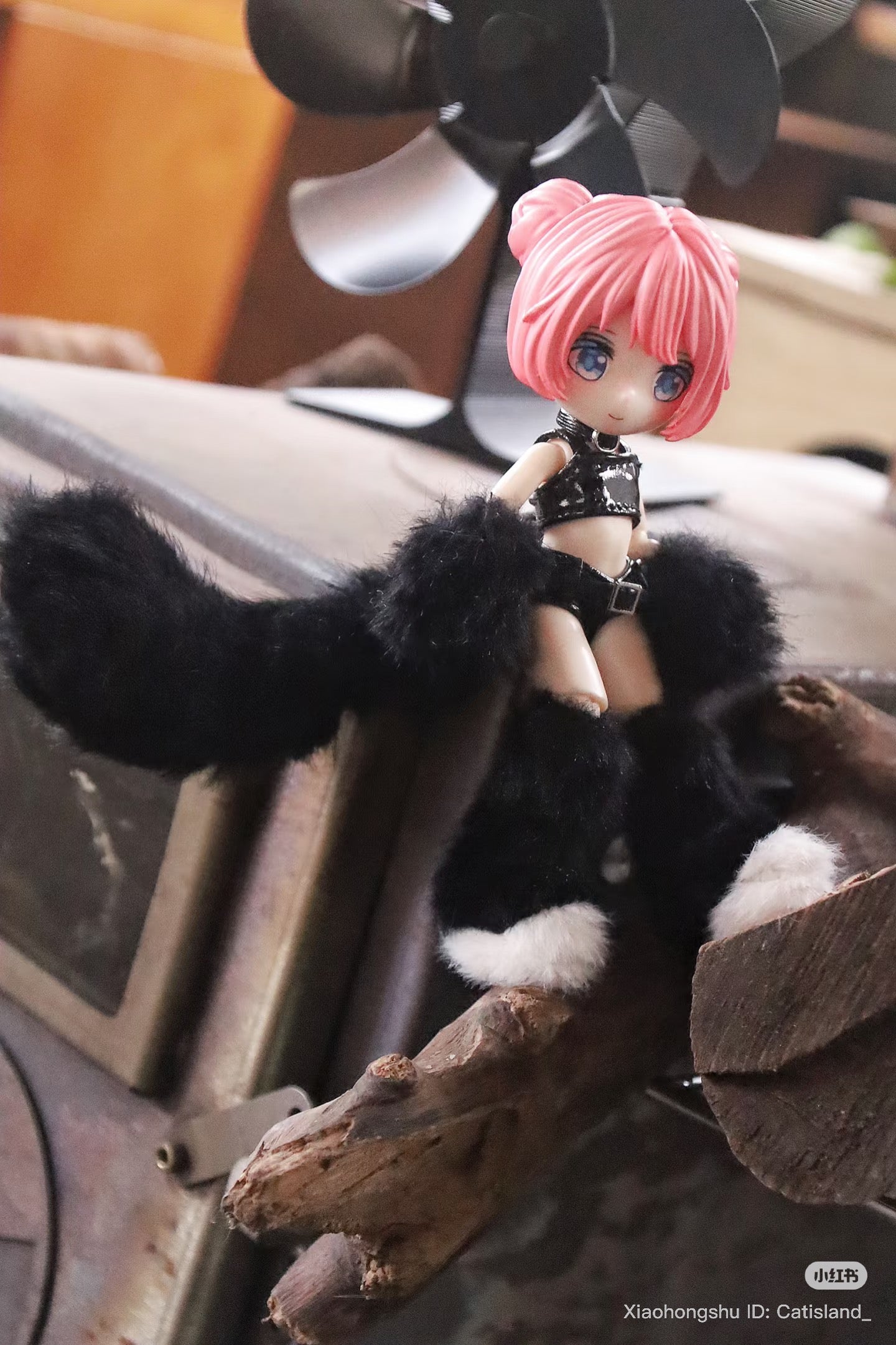 Cat Island-Black Cat Series articulated figure, posed on driftwood, featuring pink hair, fuzzy warmers, and a furry tail. Preorder for September 2025 shipment.