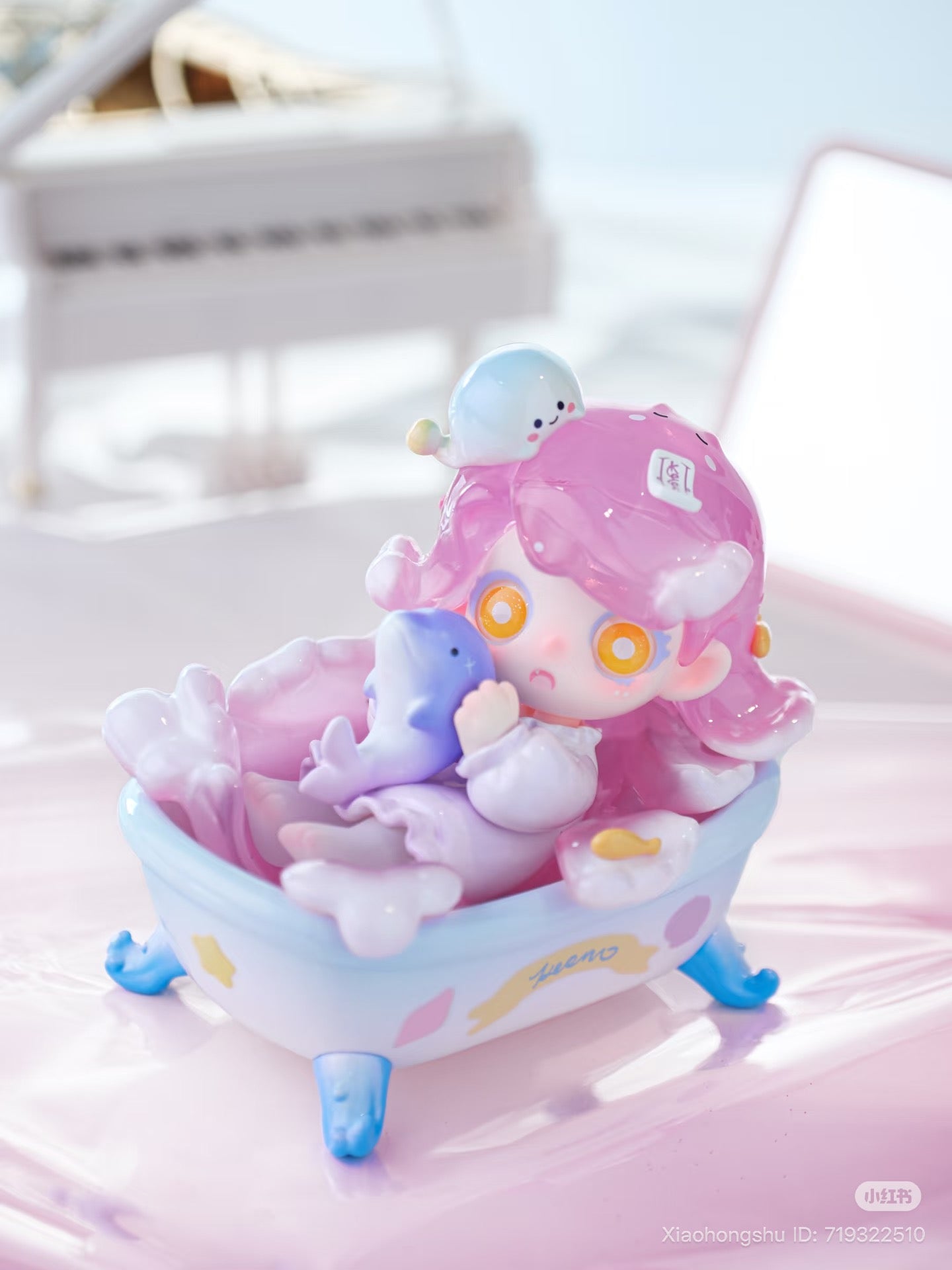 Keeno·Wish On The Sea Breeze Series Blind Box features a pastel figurine of a pink-haired character in a bathtub, hugging a tiny dolphin-like creature.