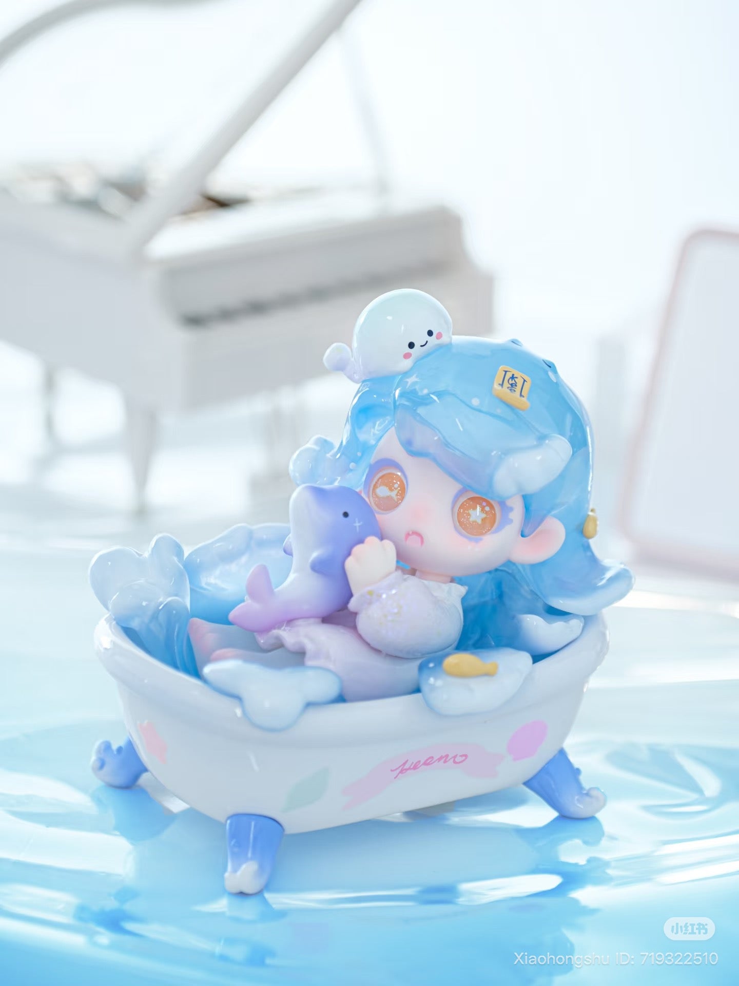 Chibi-style girl figurine from Keeno·Wish On The Sea Breeze Series Blind Box, lounging in a bathtub with a dolphin.