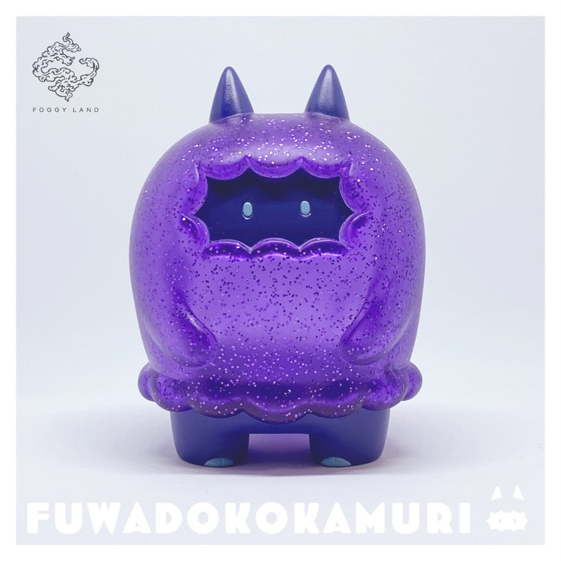 Sofubi toy of Fuwadokokamuri - Magical Amethyst by Moya, a purple cat-like animal figure with a cartoonish blue face.