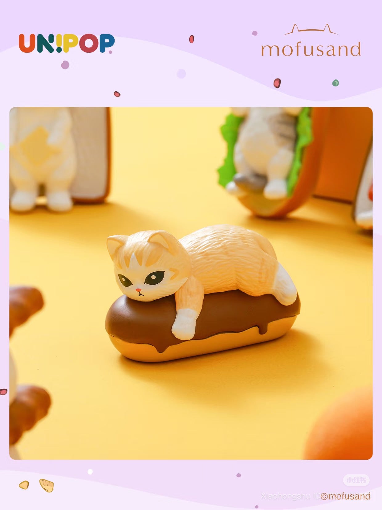 Mofusand Q Mini Blind Bag- Love Dessert Series Blind Box features a vinyl cat lounging on a chocolate-glazed éclair, part of a collectible pastry-themed toy set.