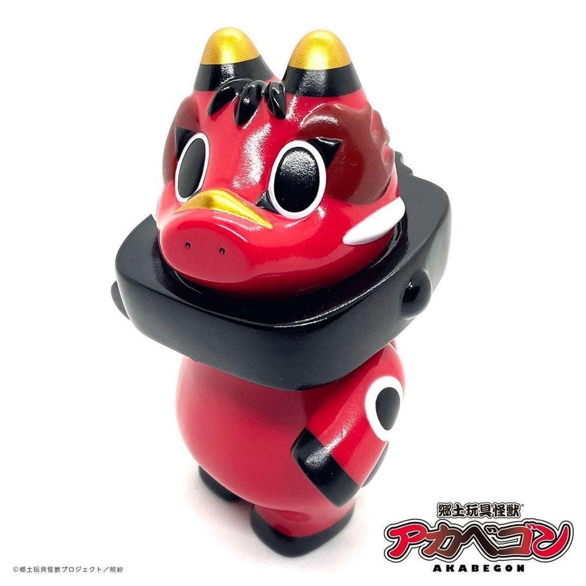 AKABEGON - Red by Teresa Chiba: A 12cm sofubi red vinyl collectible with bobble-head, oversized cartoon eyes, golden horns, and a black collar.