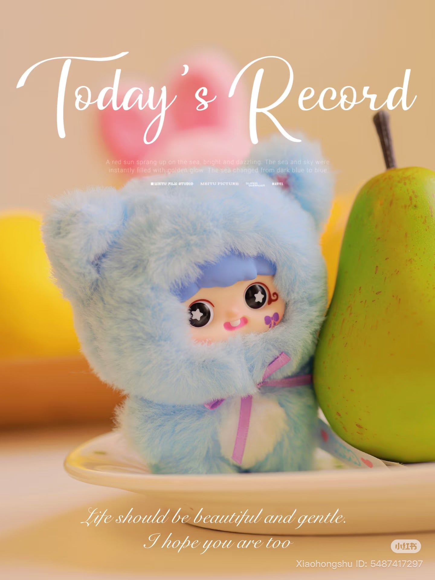 Baby Three - YAYA's first birthday plush, a cute cat-ear hoodie figure, is next to a pear. Preorder for October 2025 delivery.