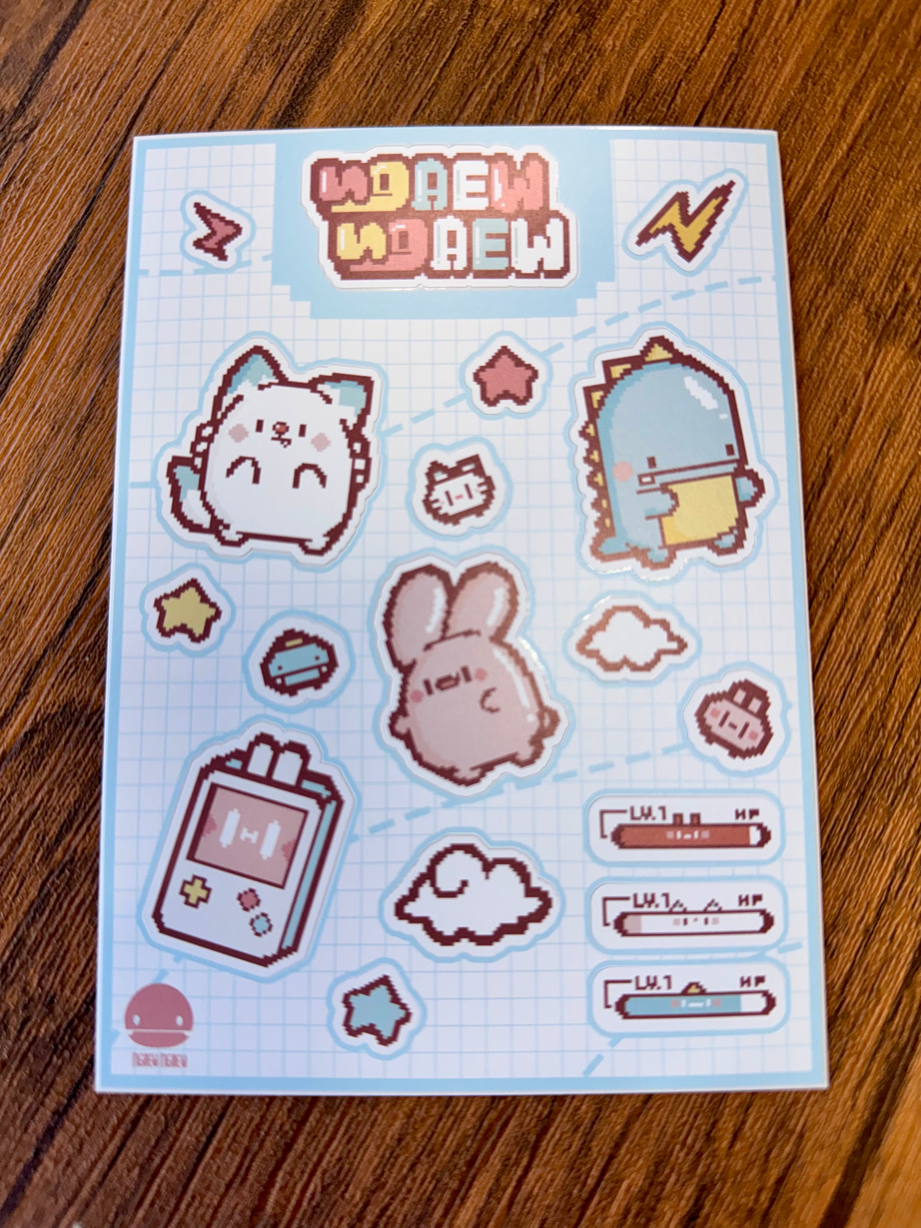 Ngaew Sticker Packs! Series 2 featuring retro, pixel-art stickers: cat, bunny, dinosaur, game console, and decorative elements, all with grid-paper background.