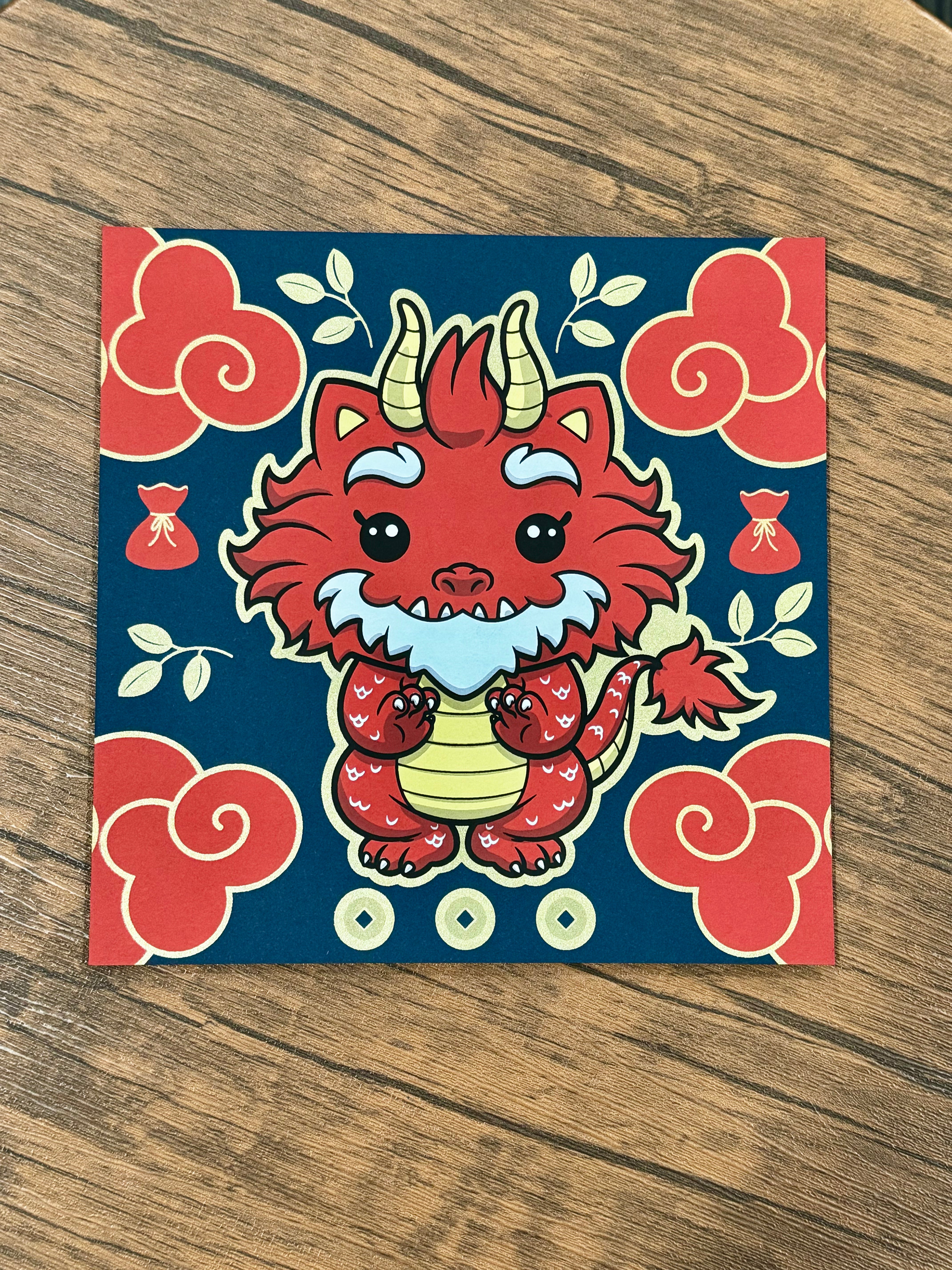 Cartoon dragon on square, white circle with square, red bag with cord, Year of the Dragon Lucky Bag items.