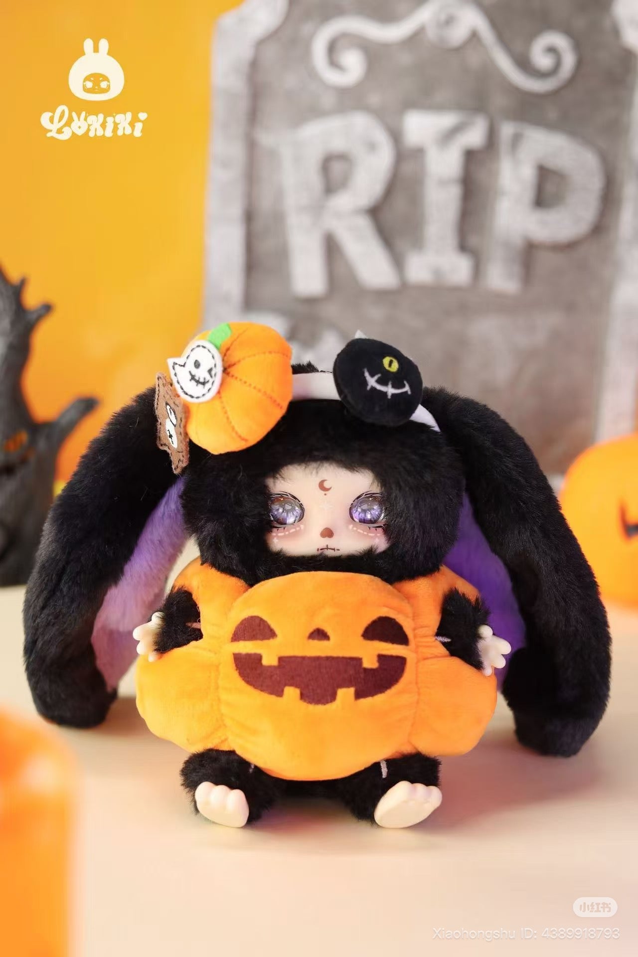 LOKKI Halloween Plush Blind Box Series: Pale-faced figure in black bunny outfit with purple eyes, holding plush jack-o’-lantern, featuring pumpkin and stitched-face patch.