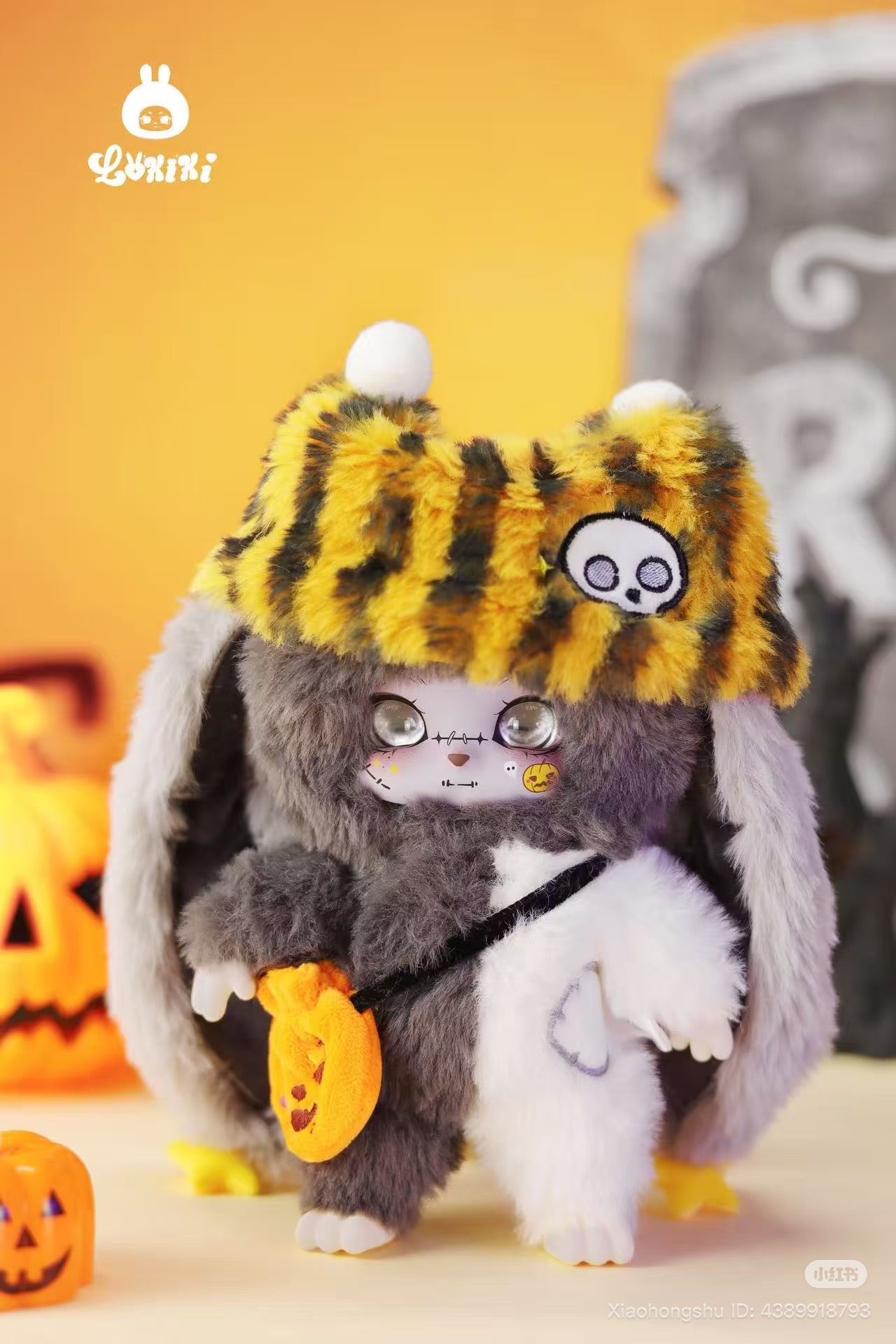 LOKKI Halloween Plush Blind Box Series: Rabbit-shaped plush in Halloween attire, with a striped hat and pumpkin bag, against a festive spooky backdrop.