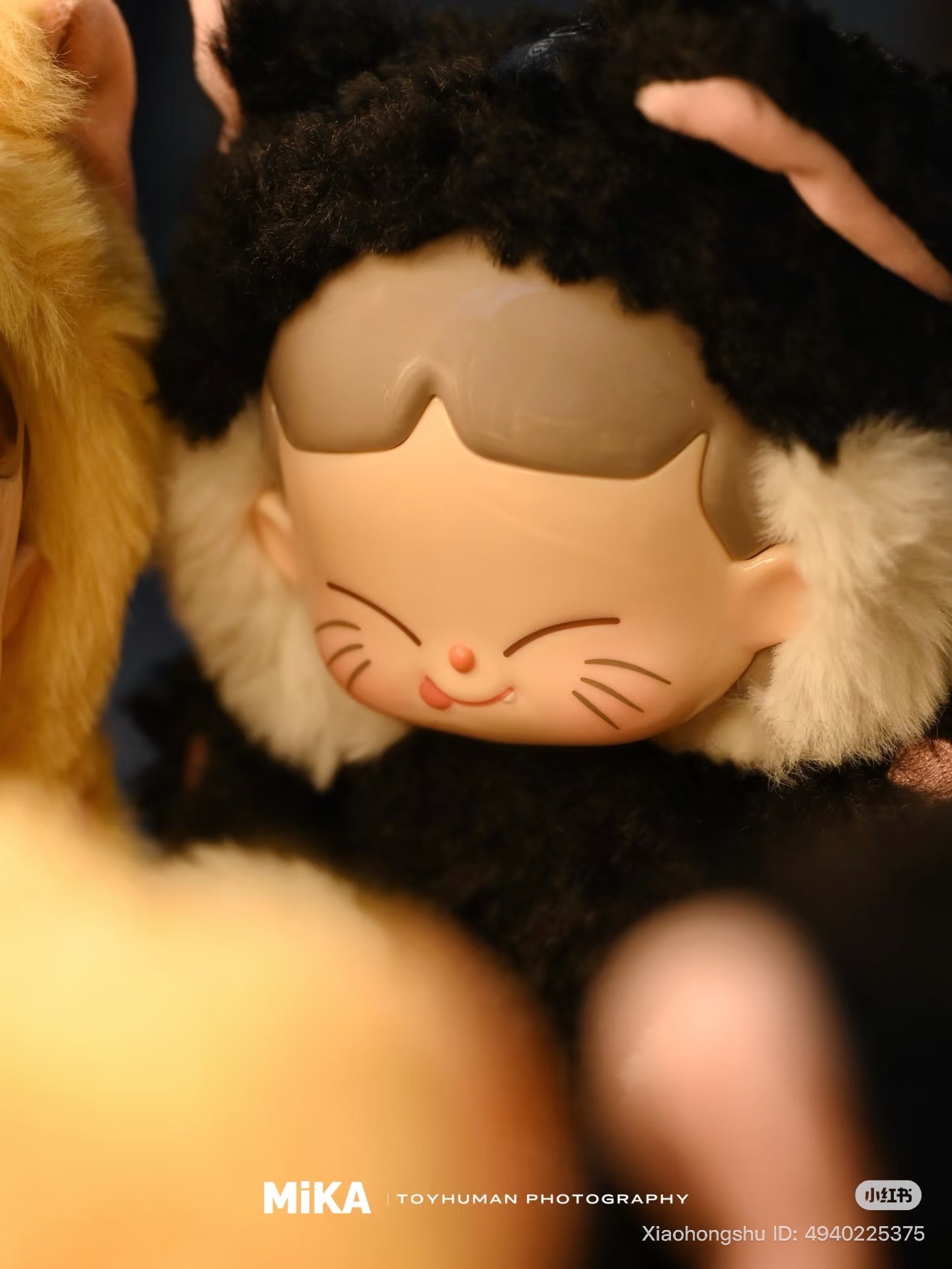 MiKA-Cat Cafe In Operation Series Plush Blind Box featuring a vinyl art toy with a fuzzy cat-ear hood, smiling face, and painted whisker lines.