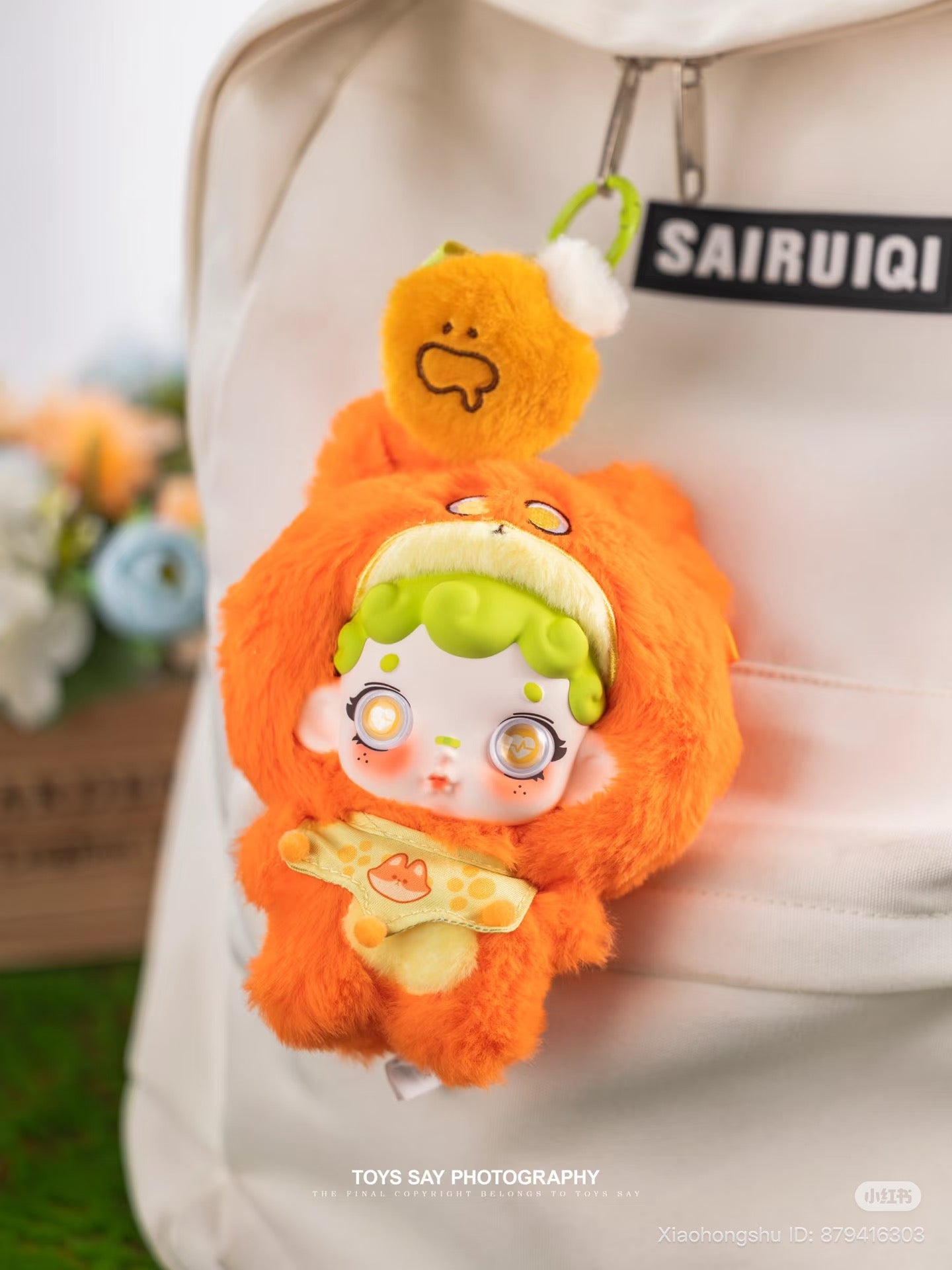 Light-beige backpack with Wonderfull ruri Animal Stealth Operation Series orange plush doll keychain, featuring a hooded design, preorder blind box from Strangecat Toys.