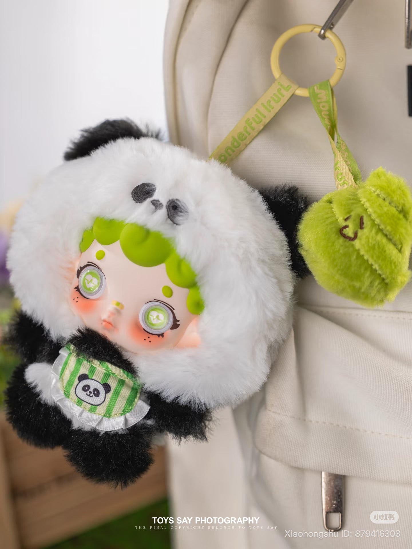 Wonderfull ruri Animal Stealth Operation Series Plush Pendant in panda suit clipped to a bag, featuring bright green hair and sparkly eyes. Preorder available.