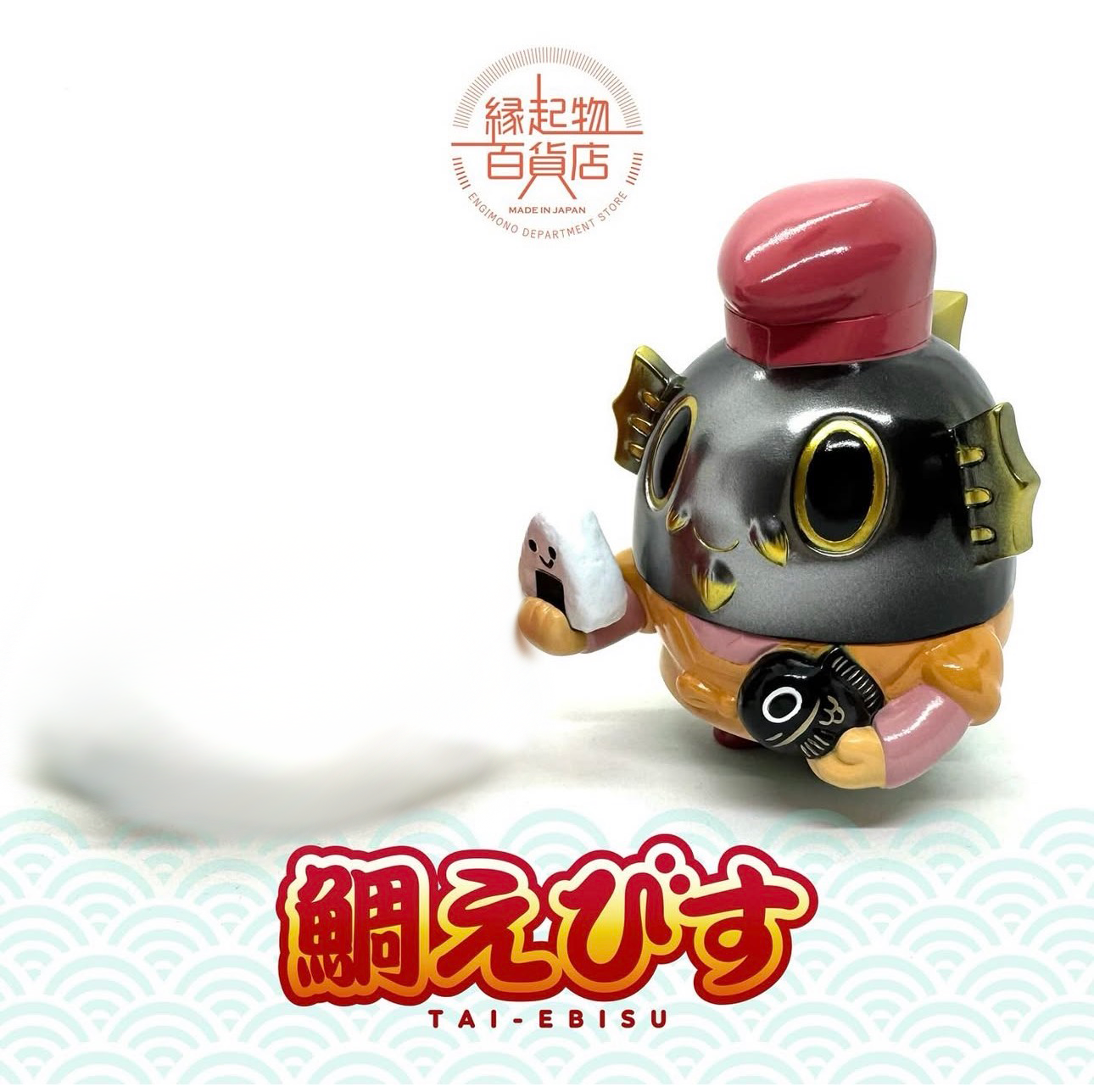 TAI EBISU (BLACK) by Teresa Chiba: A 12cm vinyl figure of Ebisu with a sea bream head, featuring a red cap, onigiri, and fish. Made in Japan.