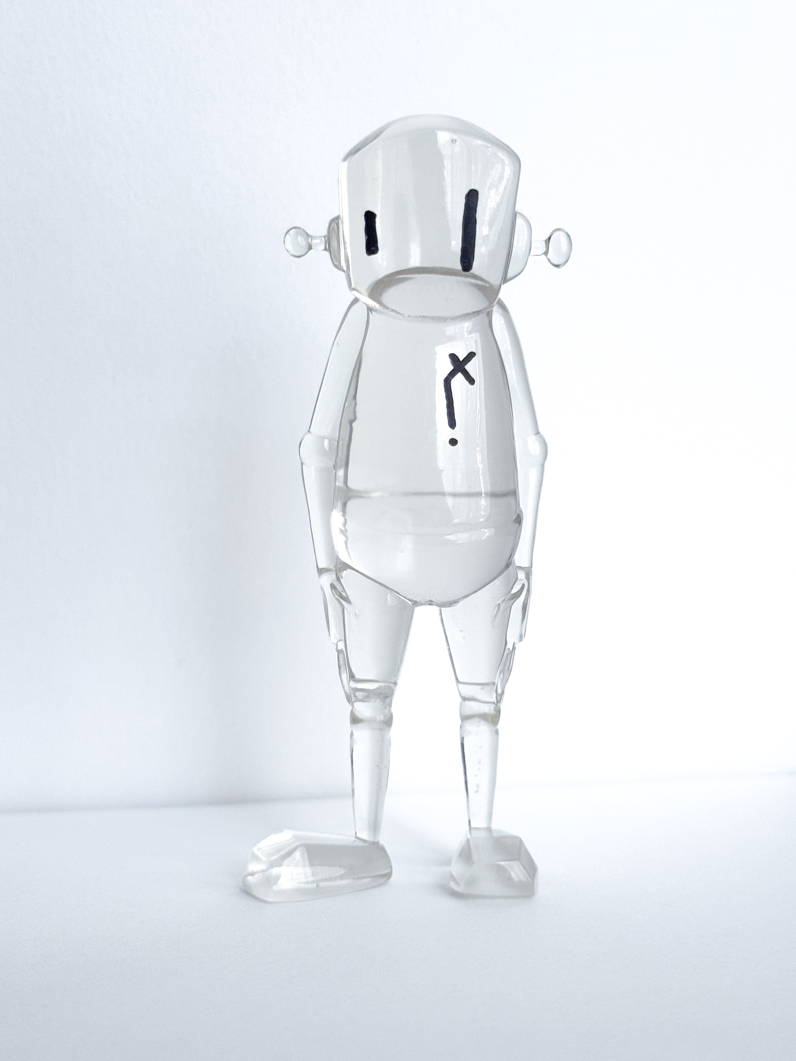 Time Will Tell - Thinking Clearly by Chris RWK: A 3.5 clear resin figure with tube arms, dome head, black eye lines, and chest X.