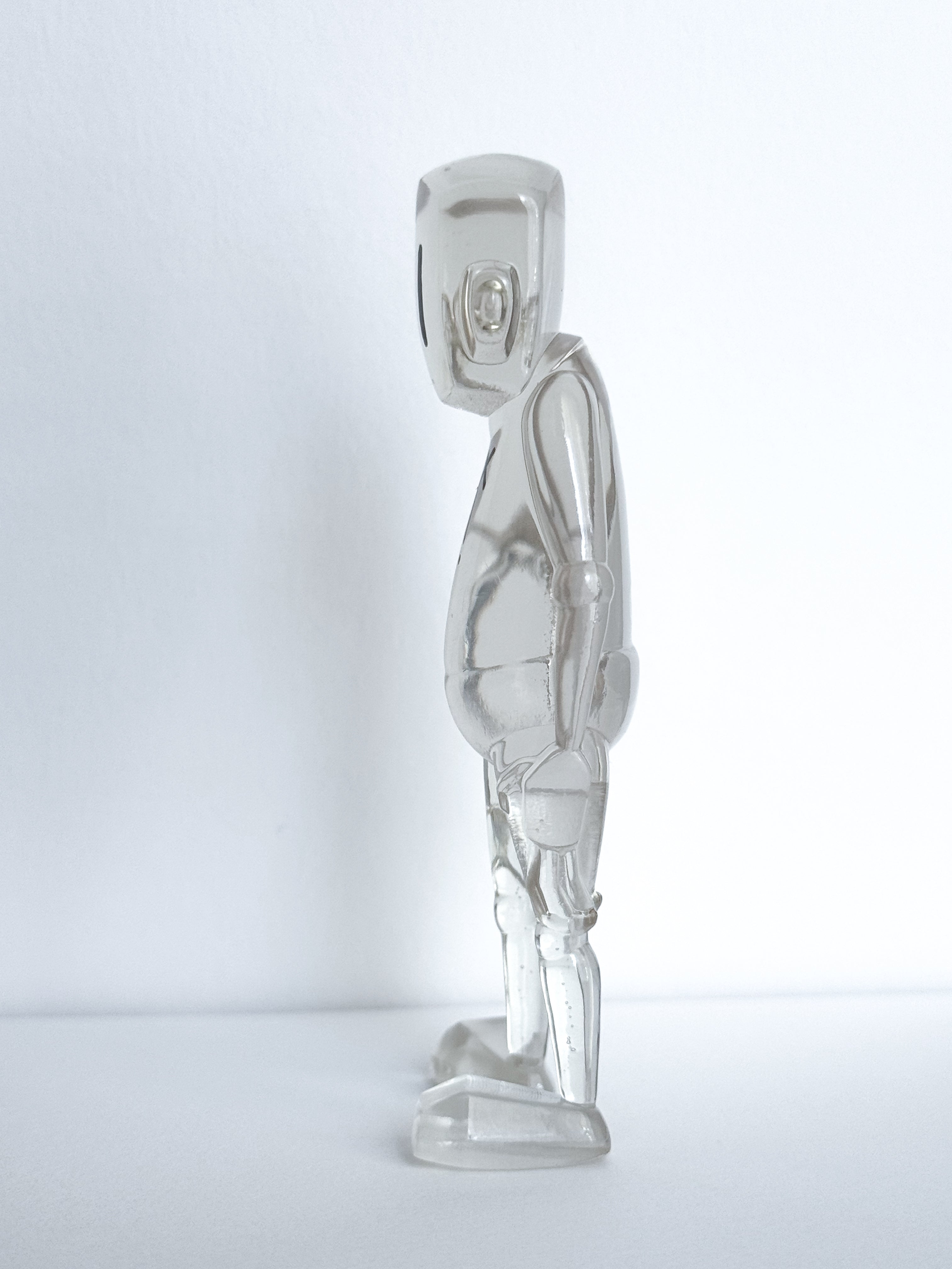 Time Will Tell - Thinking Clearly by Chris RWK: A 3.5 translucent, stylized humanoid figurine with articulated joints, showcasing minimalist design on a white background.