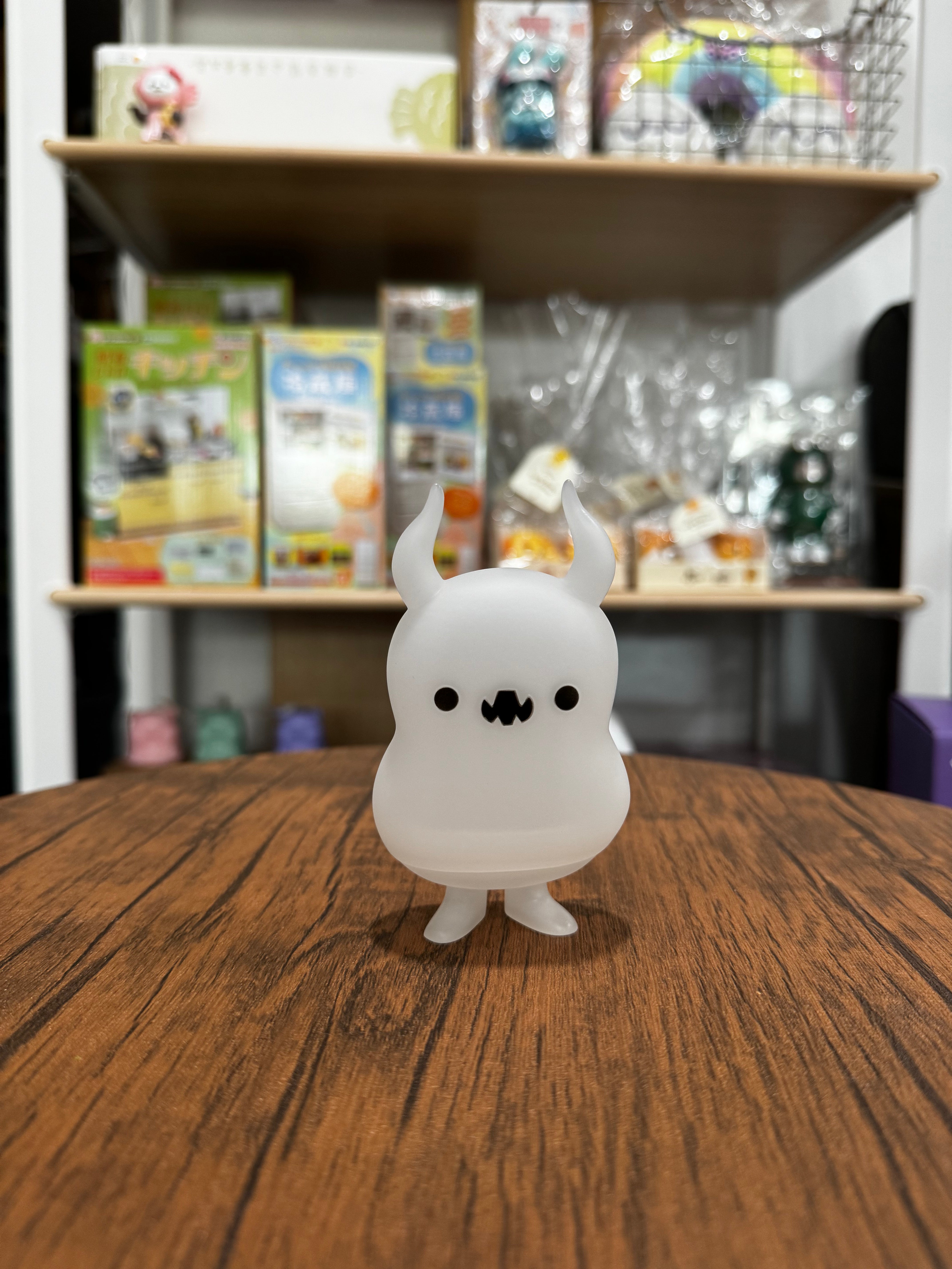 Babababa - Feeling Opaque by Chishima Konosuke, a 110mm Japanese Sofubi toy, resembling a cartoon rabbit, displayed on a wooden table.