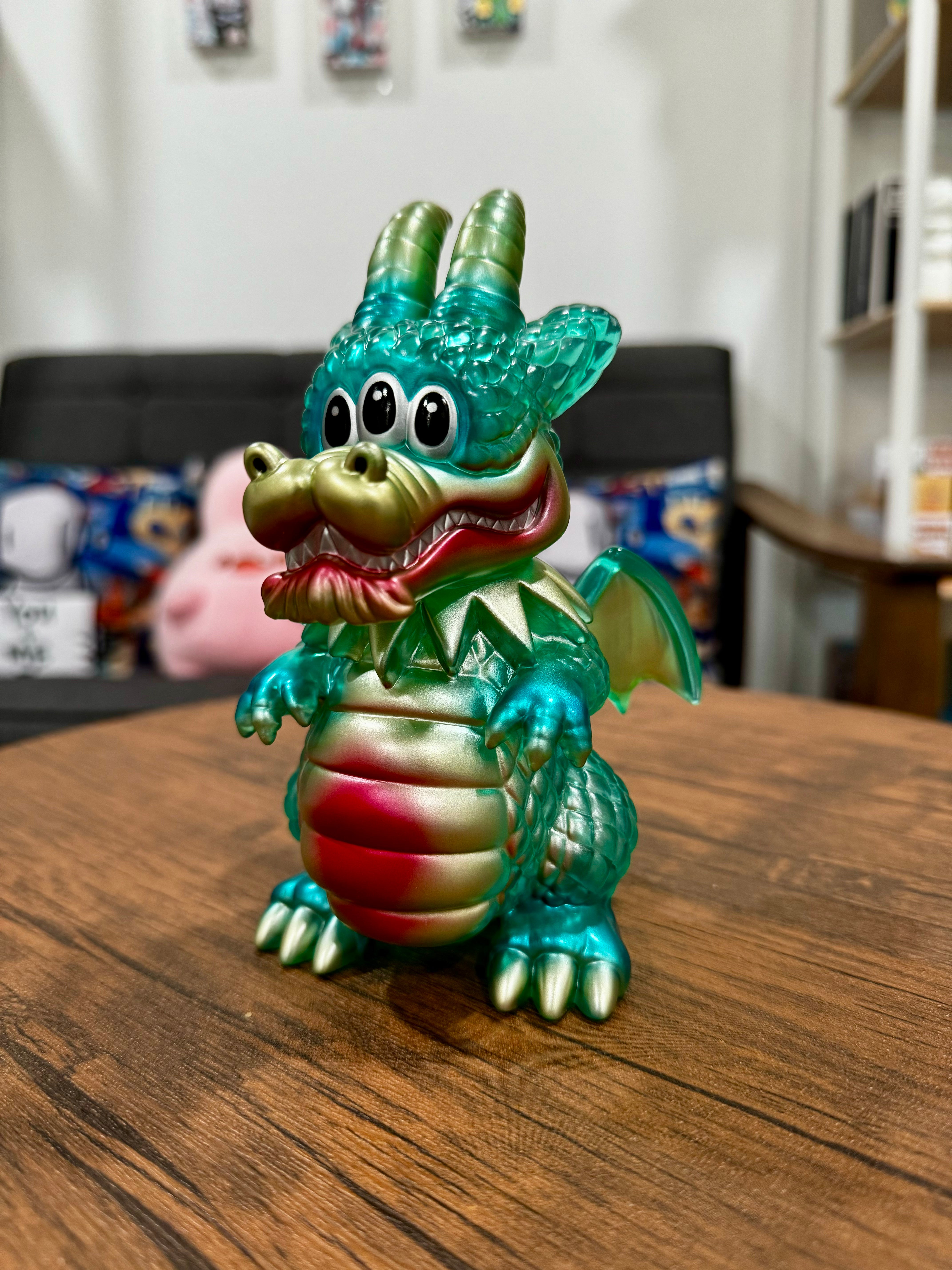 A serene Sofubi dragon figurine titled Calm Dragon Clear Mint by Art Junkie from Strangecat Toys. Toy features intricate details and a peaceful expression.
