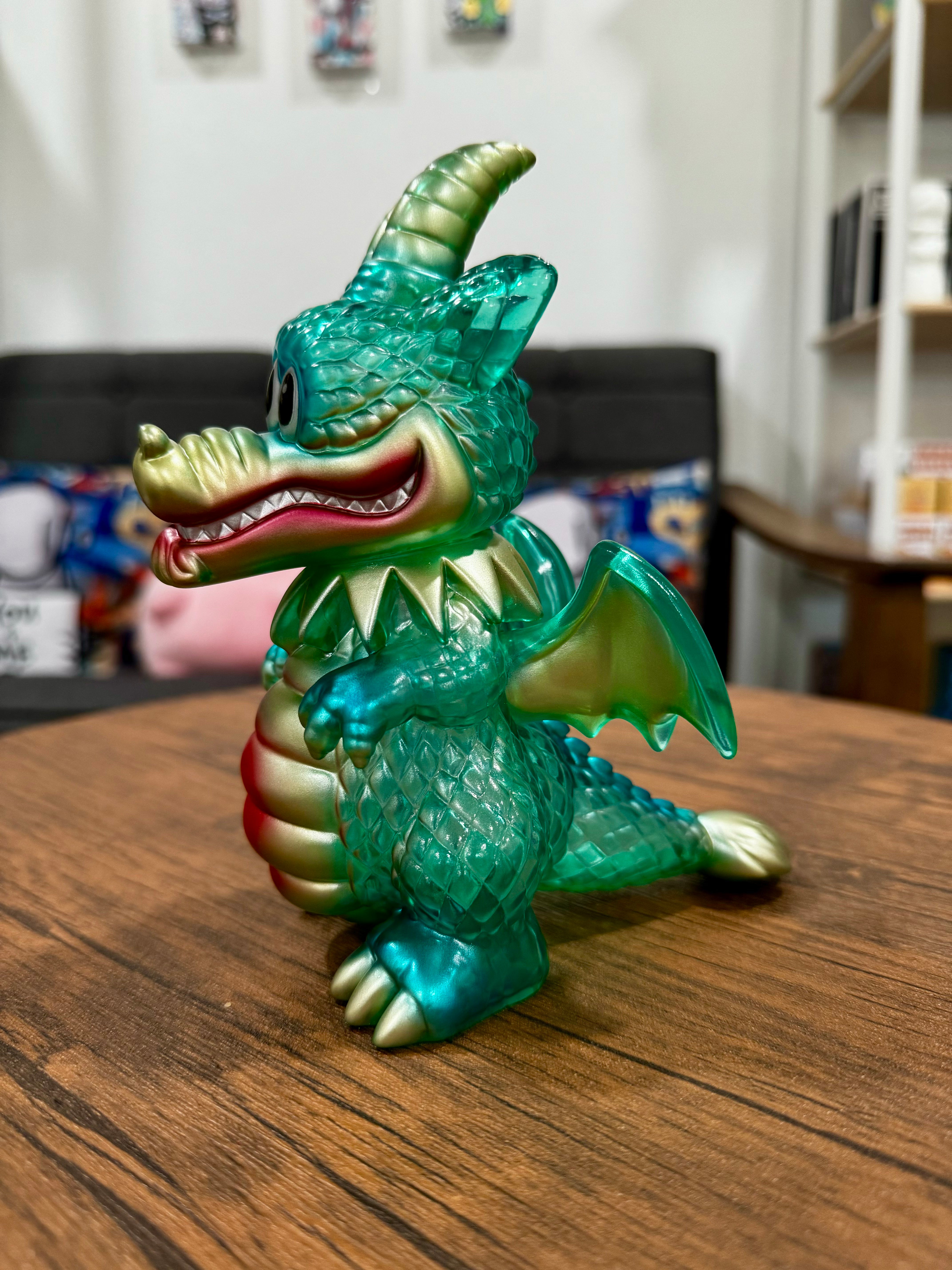 A serene Sofubi dragon figurine titled Calm Dragon Clear Mint by Art Junkie on a wooden surface. From Strangecat Toys, a blind box and art toy store.