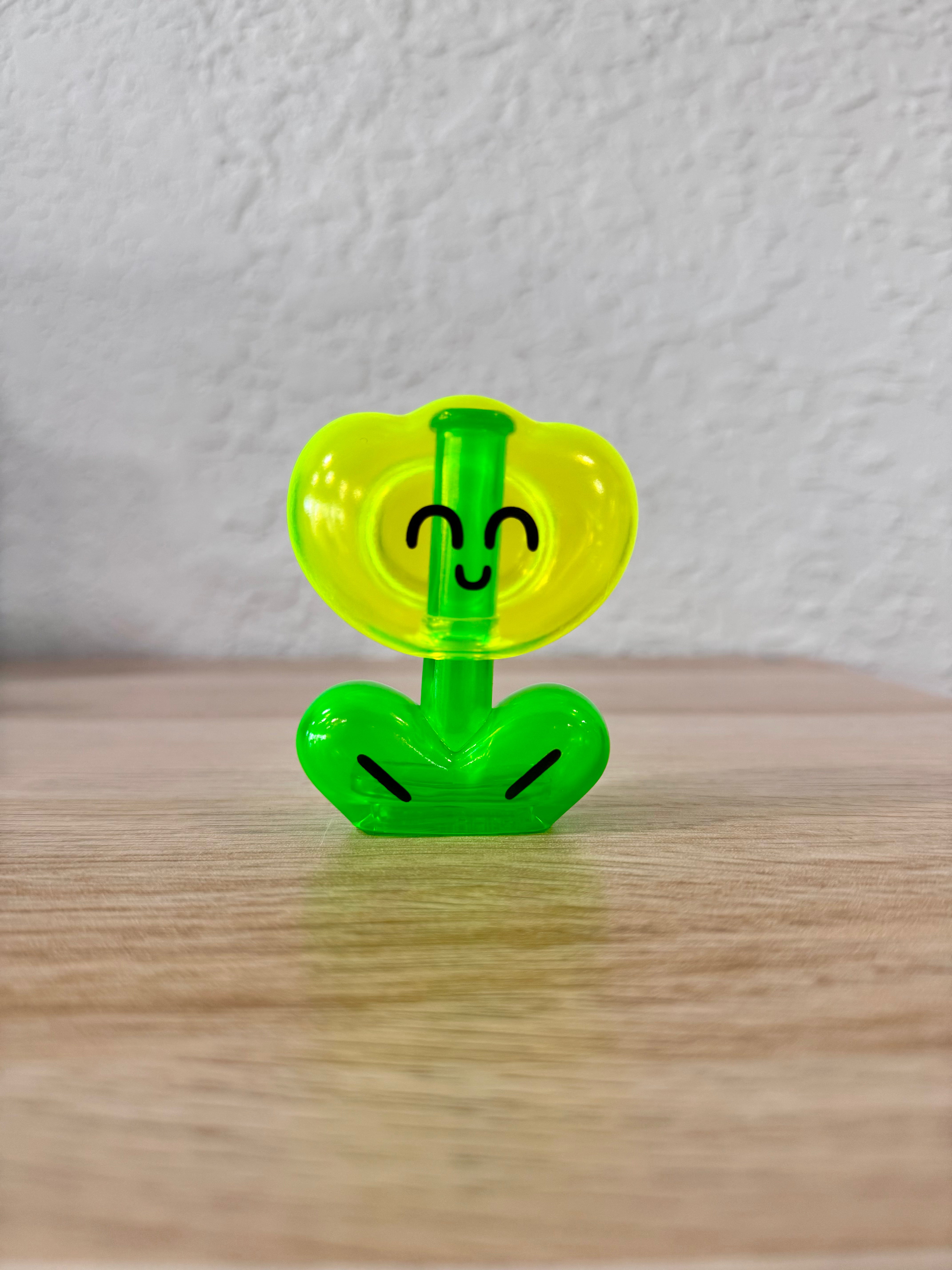 Rodriguez Neon Yellow by OHIGE no PON, a Japanese Sofubi art toy, features a whimsical face on a green and yellow figure, measuring 10cm-15cm.