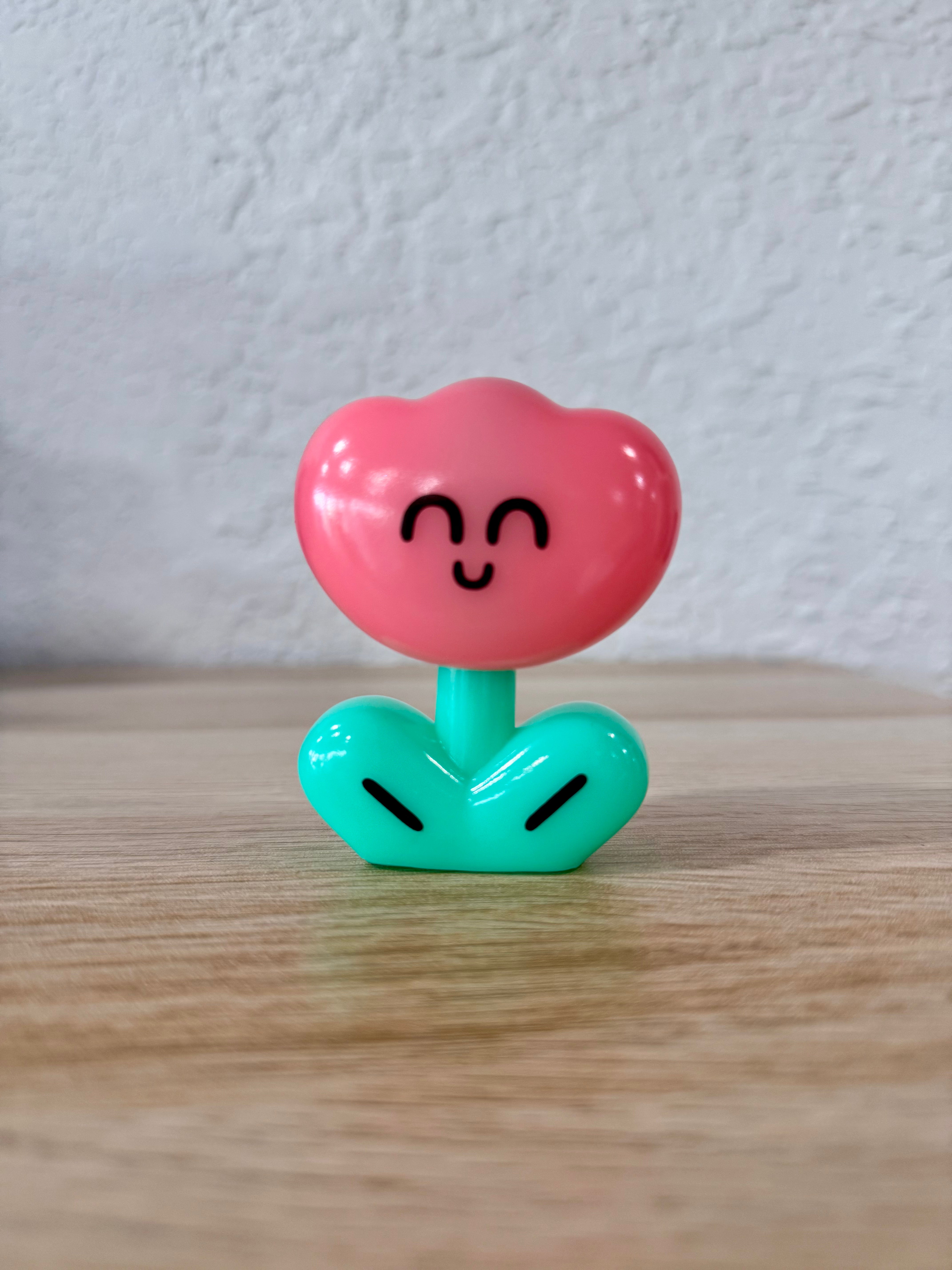 Rodriguez Milky Pink by OHIGE no PON, a small sofubi toy with a heart-shaped face, ideal for art toy collectors.