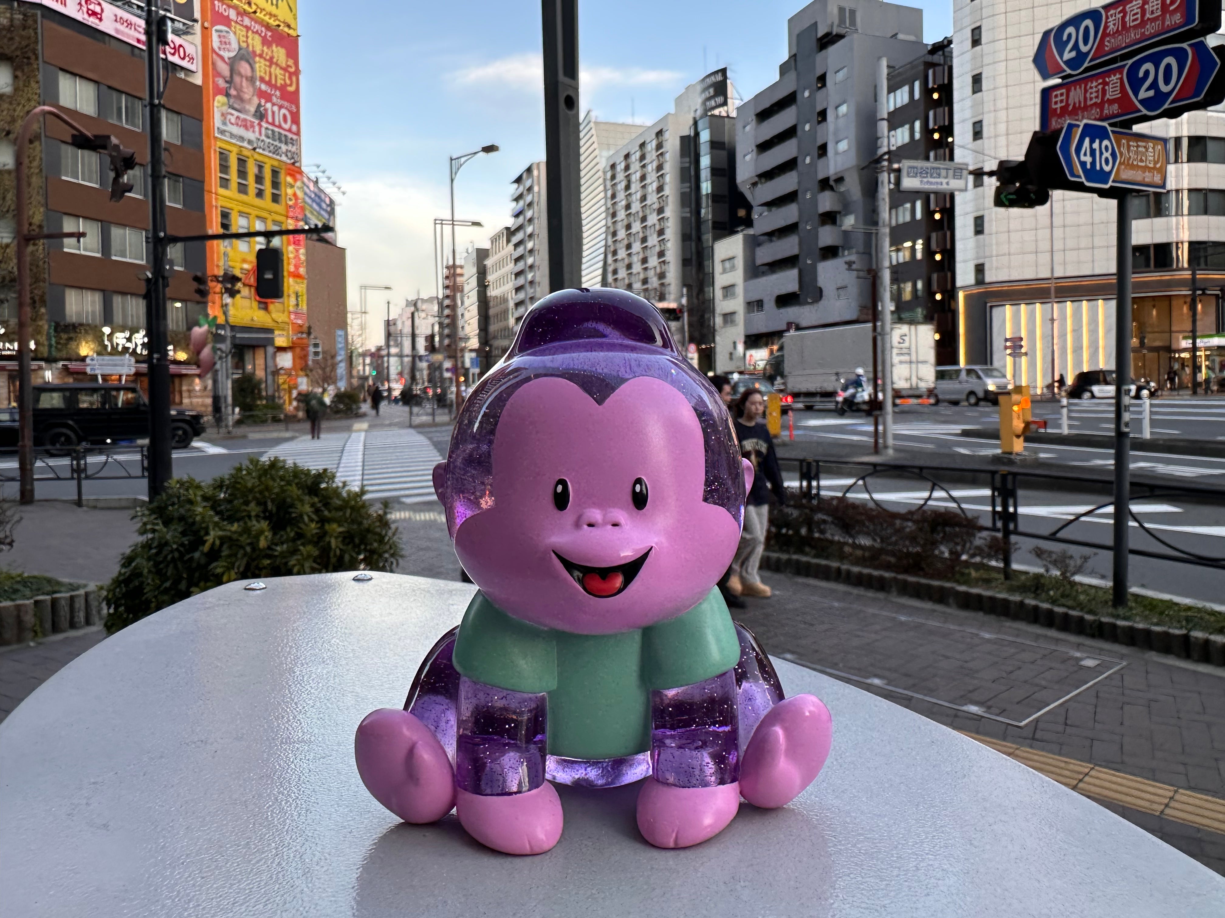 Arlo by Prime toy monkey figurine, 5 inches tall, made of high grade resin, limited to 50pcs, sitting on a table in a city street.