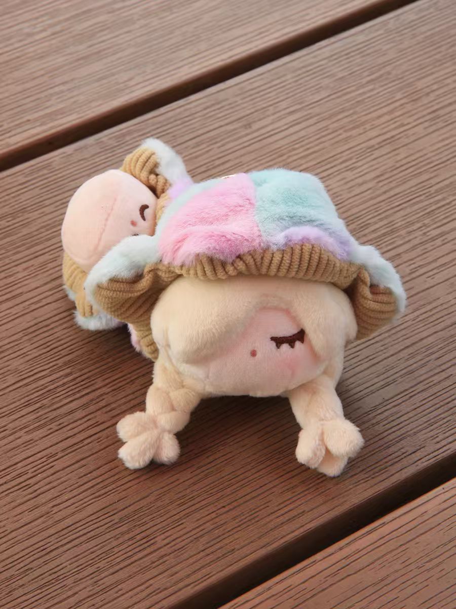 Little Mushroom Plush Pendant Blind Box featuring two stackable plush dolls with closed eyes and braid-like limbs, wrapped in soft pastel patchwork blankets.