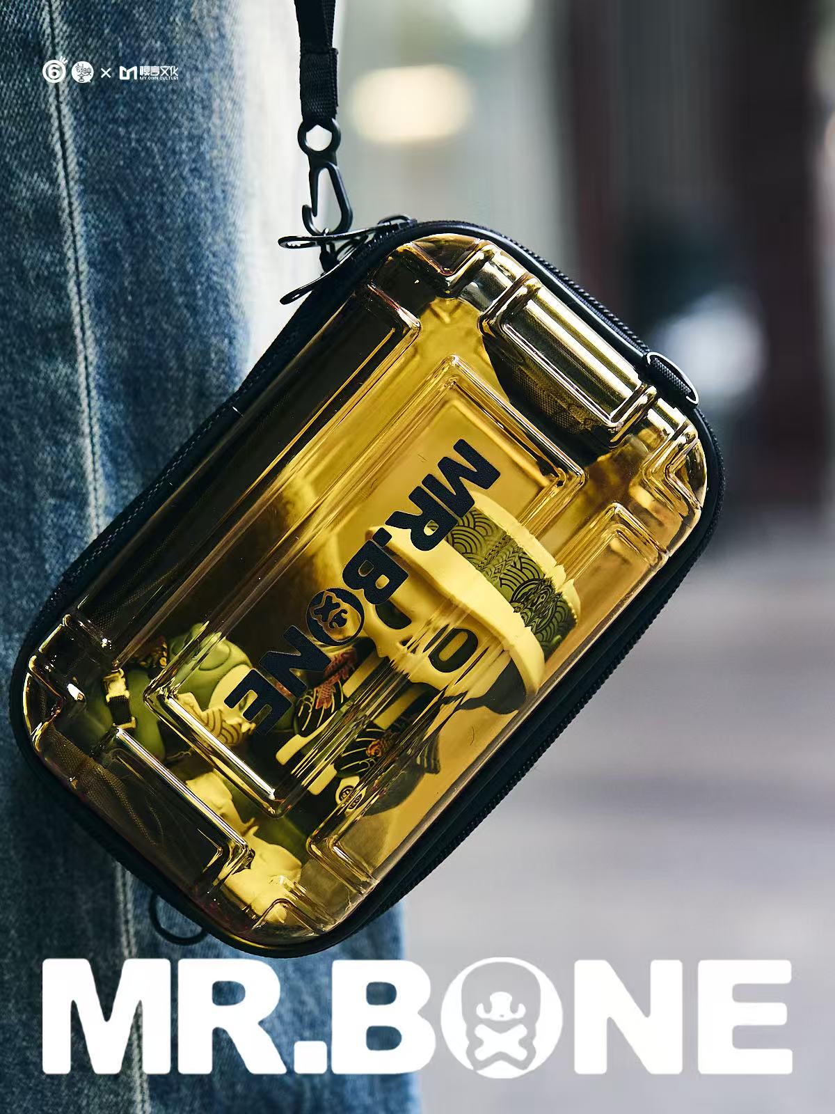 Mr Bone Yakuza Limited Set 100% pouch, transparent gold-tinted with black lettering and zipper, displays rolled-up prints inside. Preorder, includes dog and case.