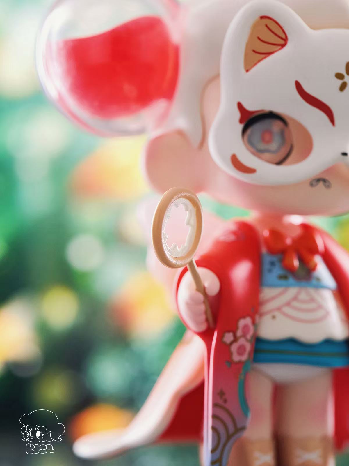 KASA 2.0 - Mystic Tales Blind Box Series figure in red kimono, holding a bubble-wand, with a white fox-mask over one eye.