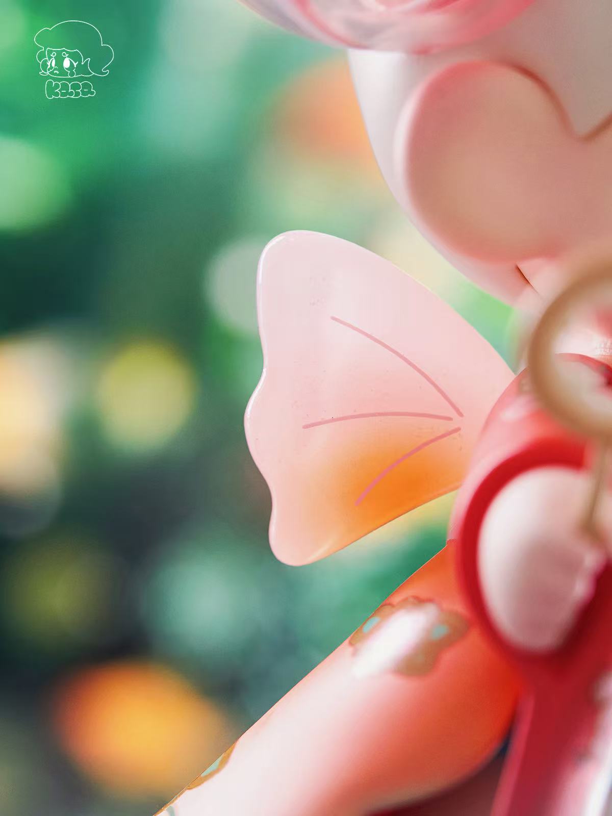 KASA 2.0 - Mystic Tales Blind Box Series: A pastel vinyl art-toy with semi-translucent butterfly wing in focus. Part of a collectible series.