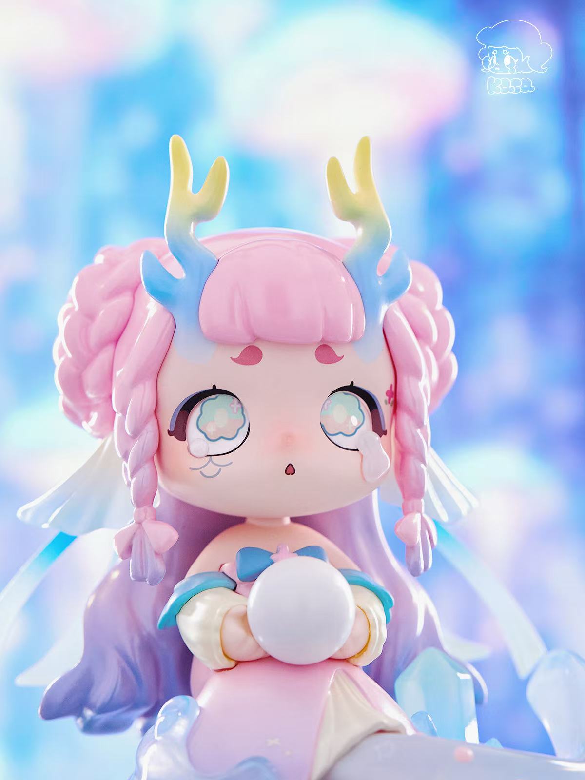 KASA 2.0 - Mystic Tales Blind Box Series: Chibi figure with braided pink hair, antler-like horns, translucent wings, holding a white orb, wearing a pastel dress.