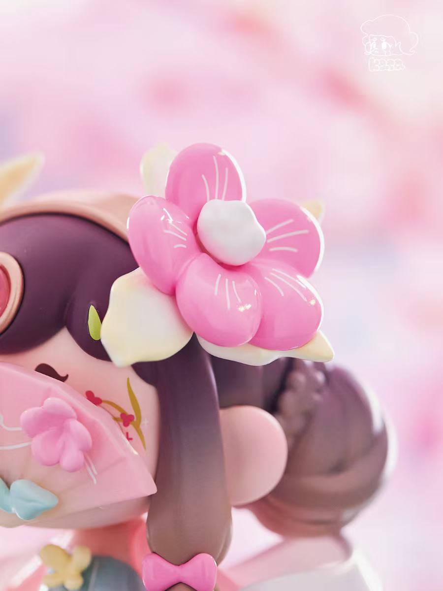 KASA 2.0 - Mystic Tales Blind Box Series figurine, featuring a girl with braided hair, pink flower ornament, and blossom fan, crafted in soft pastel hues.