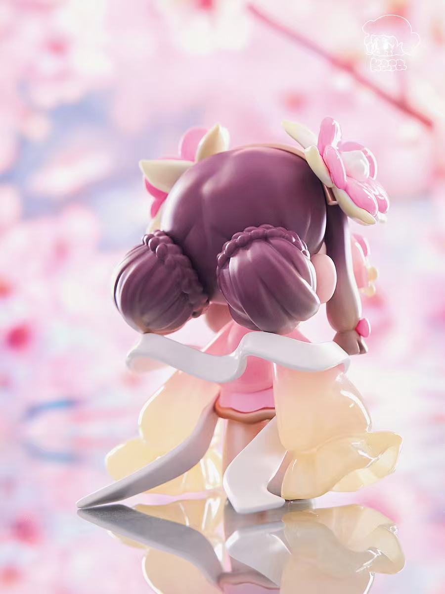 KASA 2.0 - Mystic Tales figure in pastel kimono, braided buns, floral ornaments, on reflective surface, part of blind box series from Strangecat Toys.
