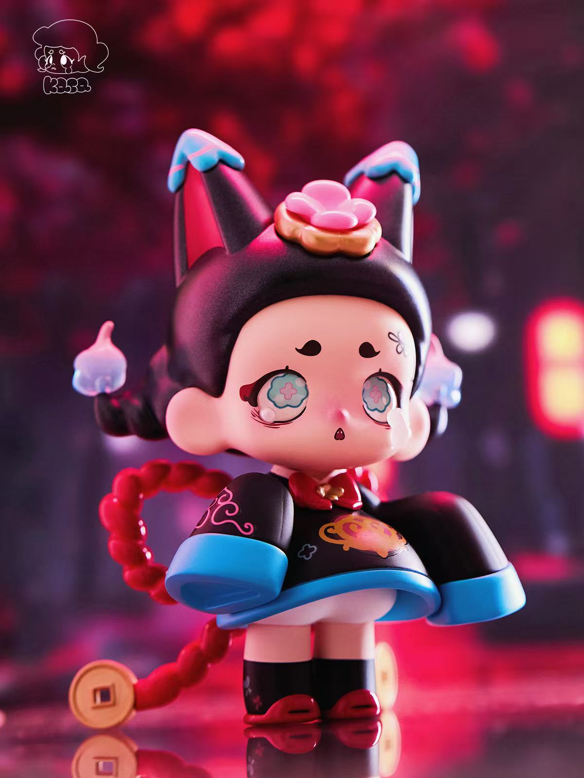 KASA 2.0 - Mystic Tales Blind Box figure, a chibi girl in a cat-ear hood, black robe, with a red cord tail, on a reflective surface.