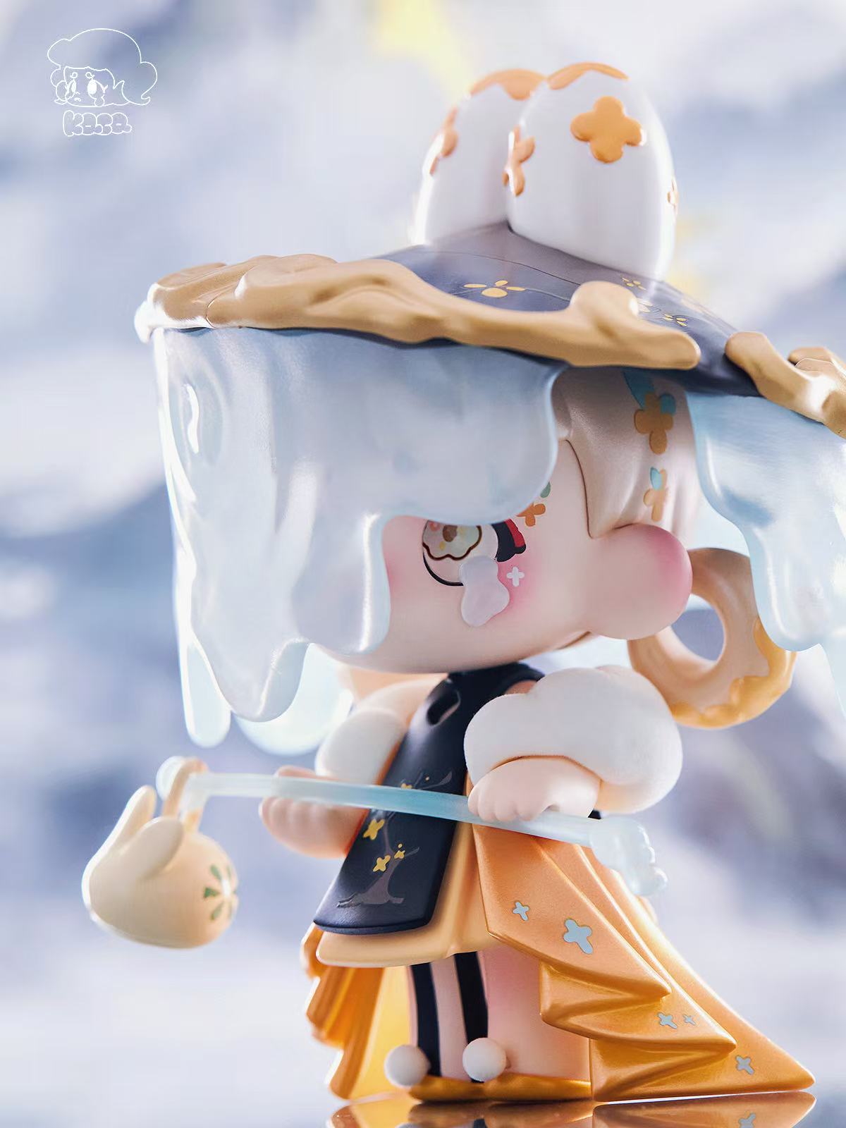KASA 2.0 - Mystic Tales Blind Box Series: Chibi vinyl art toy with melting hat, floral motifs, and rabbit staff, dressed in layered, patterned outfit.