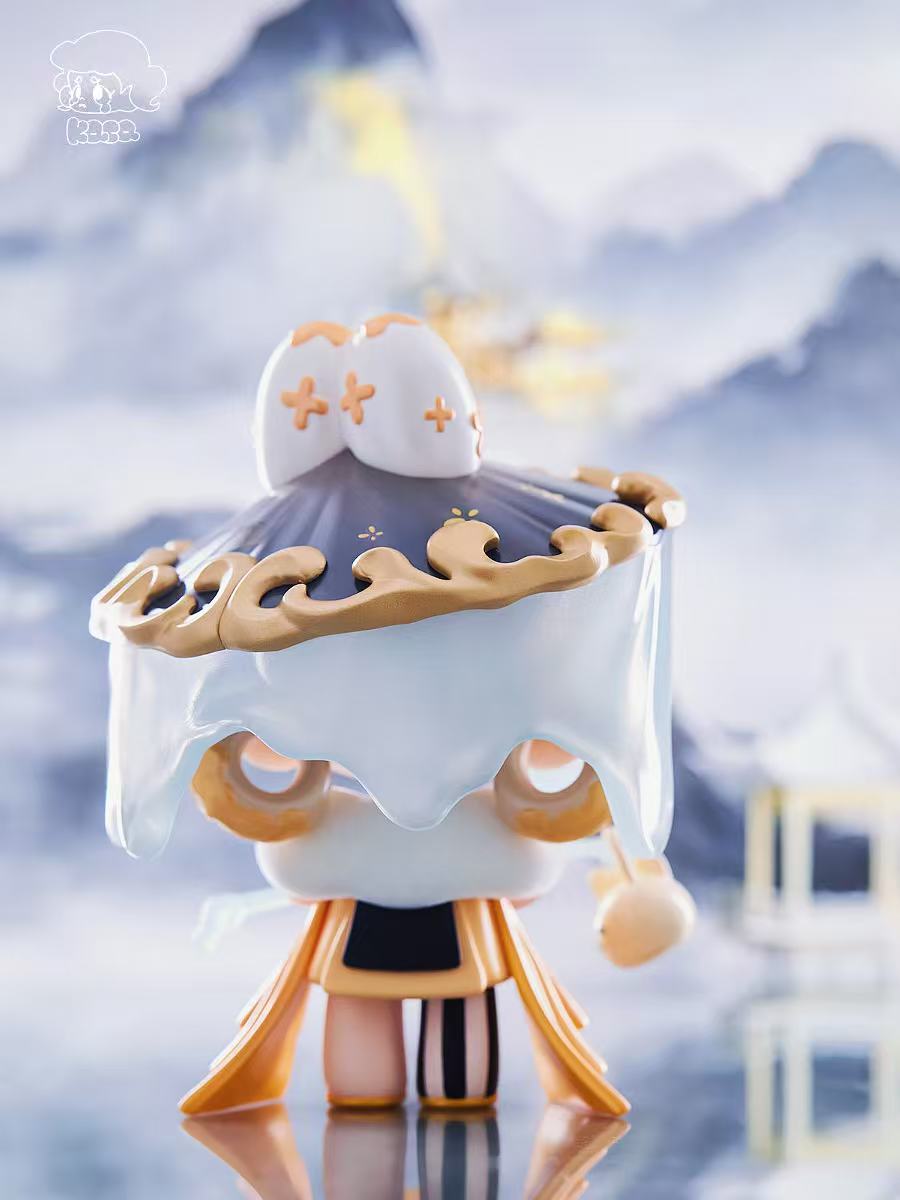 KASA 2.0 - Mystic Tales Blind Box Series: A vinyl figure in a gold-trimmed hat and robe stands on ice, surrounded by snowy mountains.