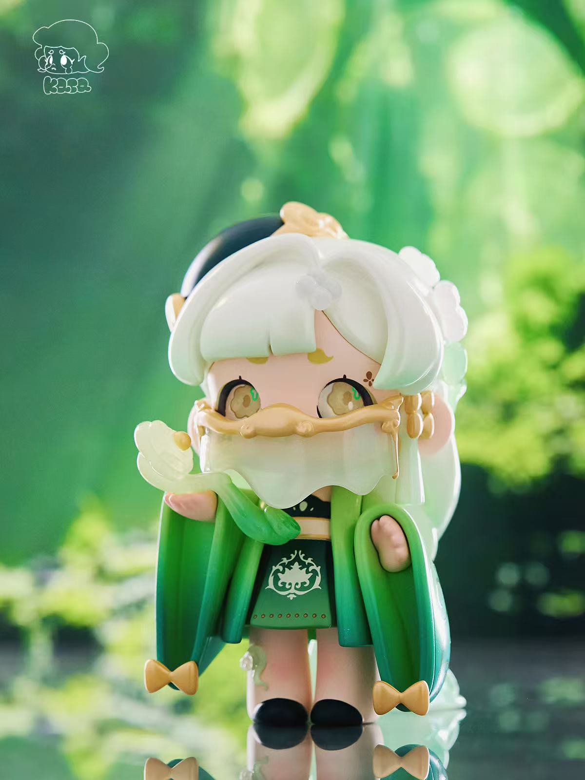KASA 2.0 - Mystic Tales Blind Box Series toy, with mint hair, ornate green outfit, flower petal accessory, and gold facial band.