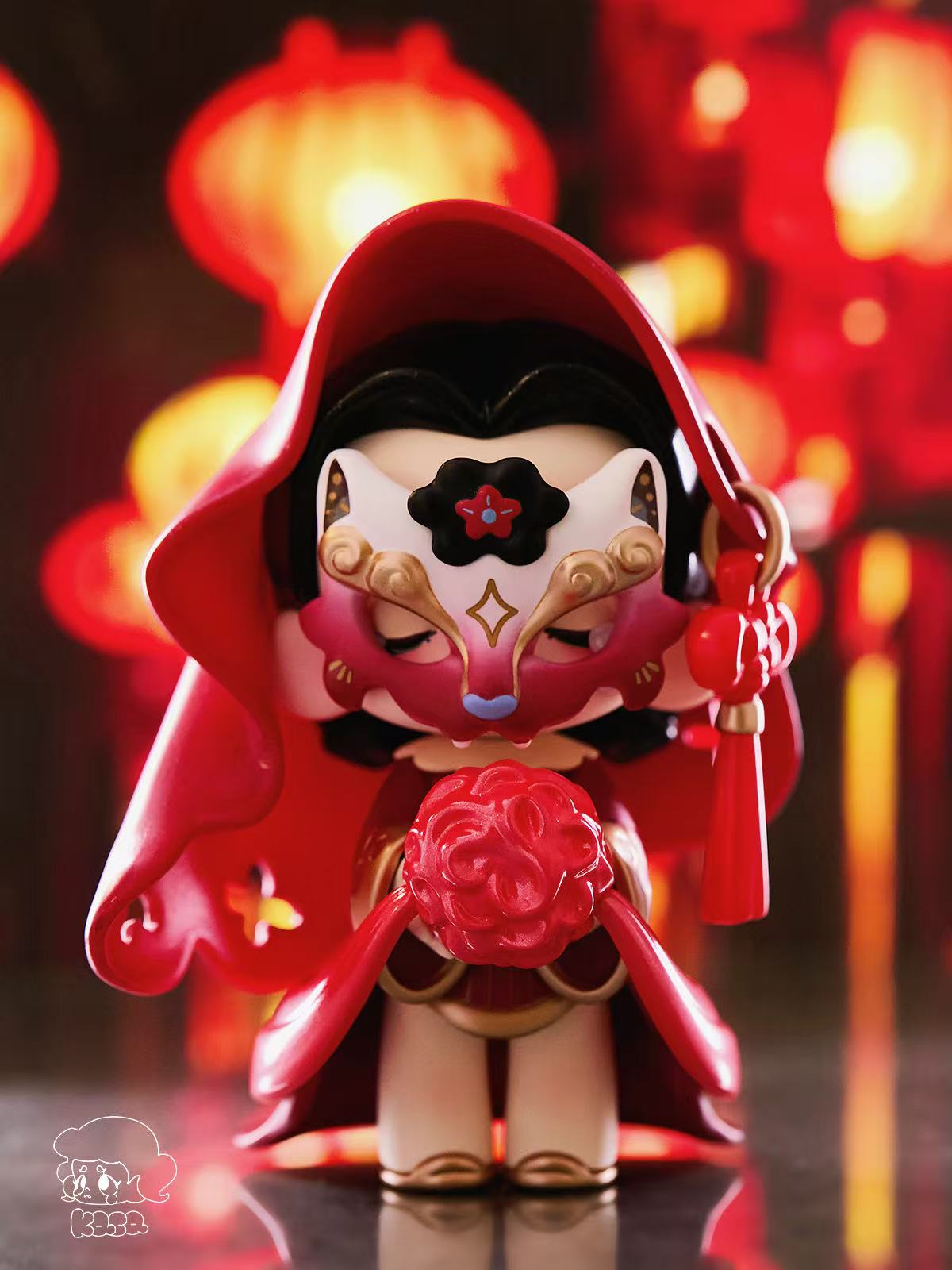 KASA 2.0 - Mystic Tales Blind Box Series figurine in a red cloak with gold accents, holding a sculpted flower, set against a festive lantern-lit backdrop.
