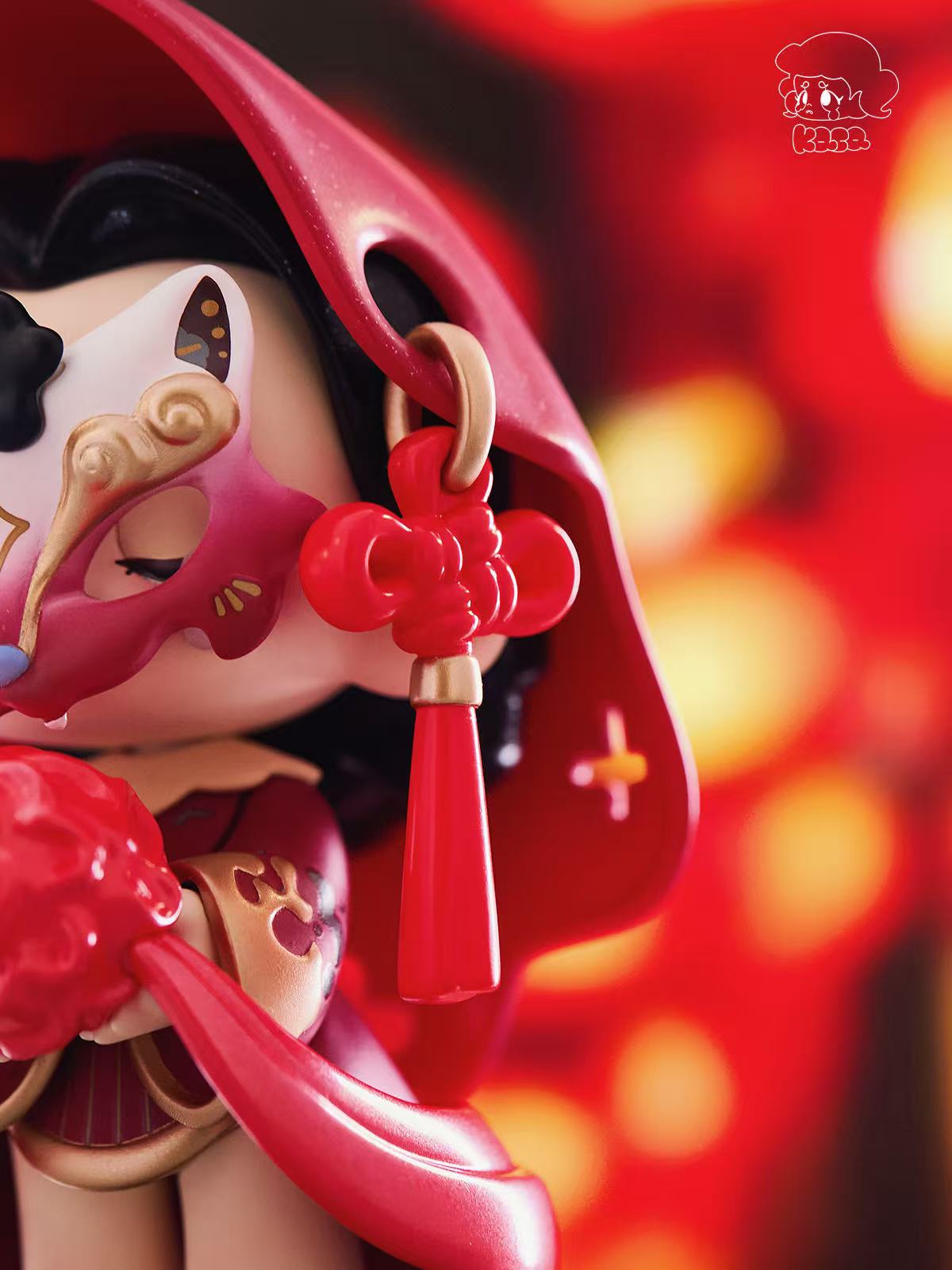KASA 2.0 - Mystic Tales Blind Box Series figure in glossy red cloak with a cat mask, holding a red ornament, featuring a tassel knot.