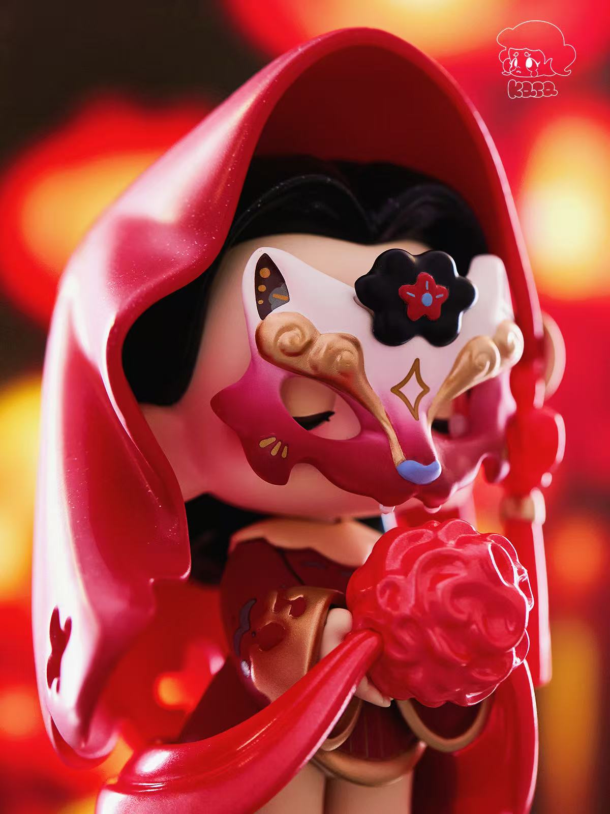 KASA 2.0 - Mystic Tales Blind Box figure wearing a red cloak, gold-accented half-mask, holding a flower-shaped lantern. Part of a collectible series.