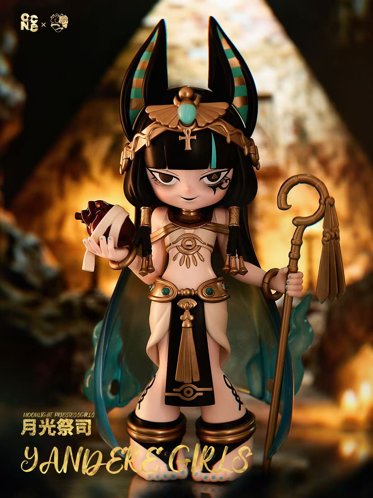 Yandere Girls The Priestess collectible: Ancient-Egypt-inspired figure with Anubis headdress, gold staff, and bandaged heart, embodying moonlit mystery. Preorder now.