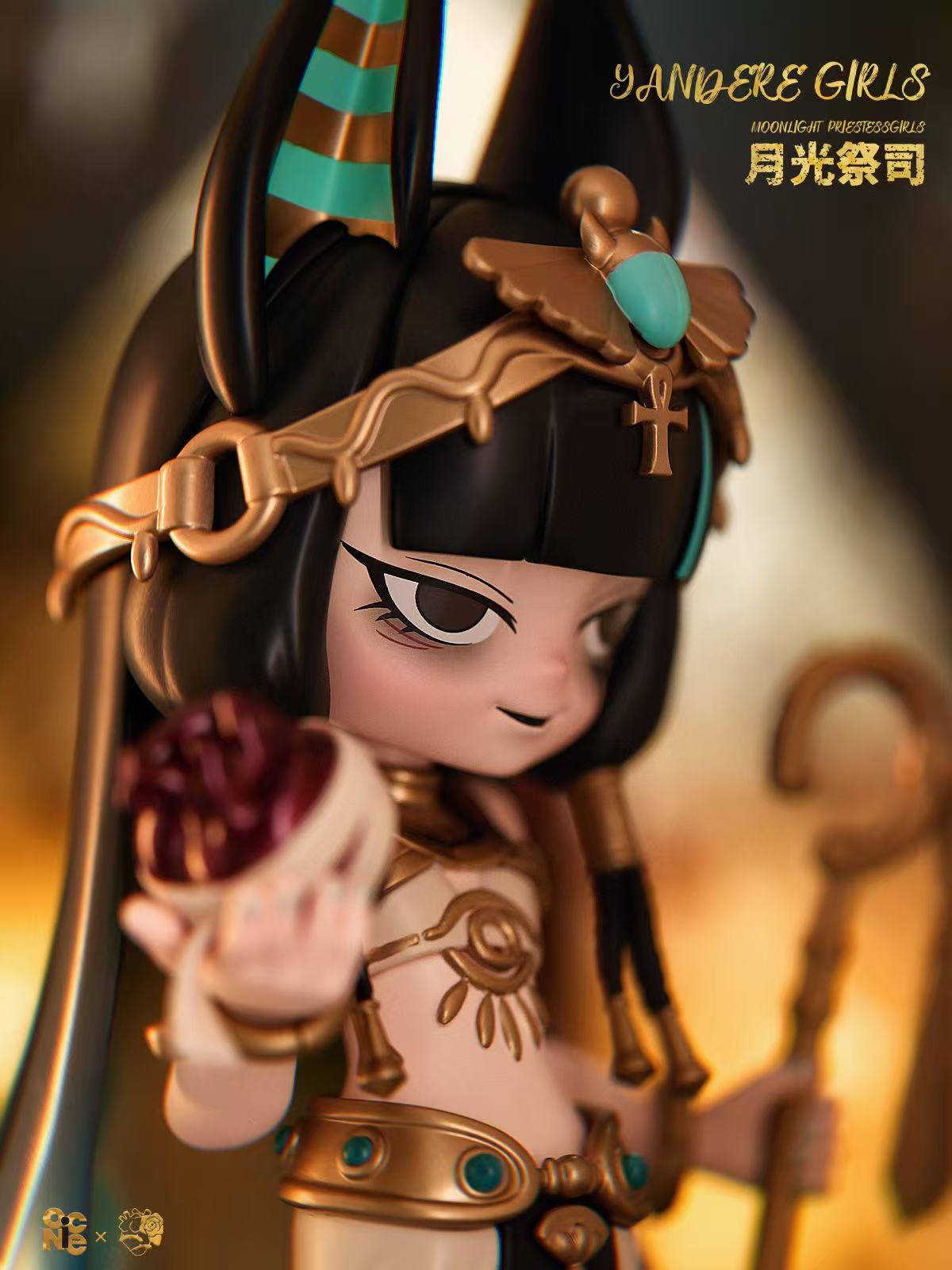 Yandere Girls The Priestess figurine, featuring an Egyptian-themed priestess with jewelry, ankh headpiece, heart object, and staff. Preorder, 8-inch resin/PVC collectible.