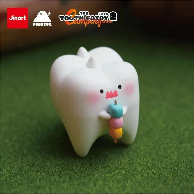 Toy tooth holding a candy stick and toothpick, cartoon character with lightning bolt, red square with white text, logo with orange and black text, and blurry blue object with brown stem from Tooth Fairy Series 2 Happy Camping Blind Box Series.
