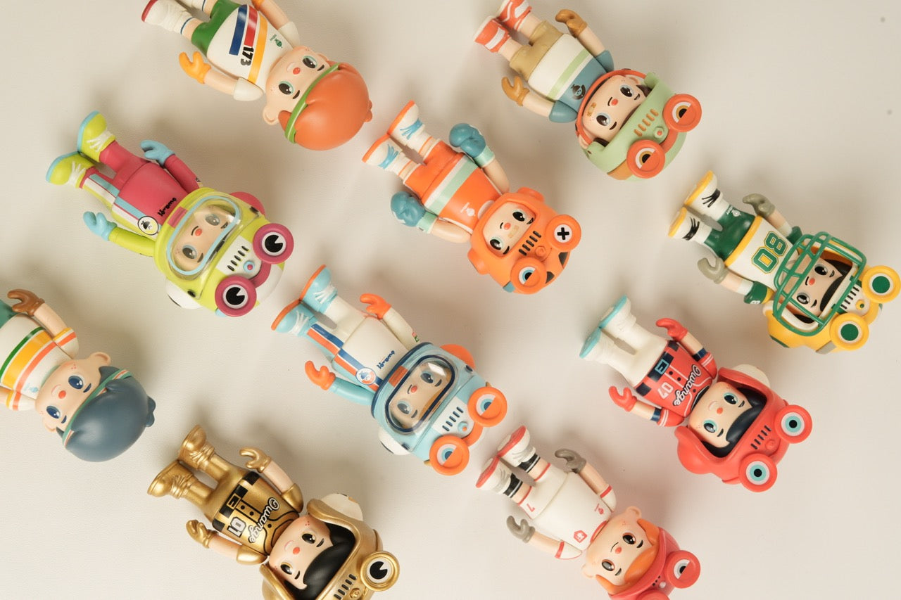 Top-down view of OWANGEBOY-All Stars Sports Blind Box Series, featuring stylized toy figures in sporty outfits with helmets or masks, arranged in a loose grid.