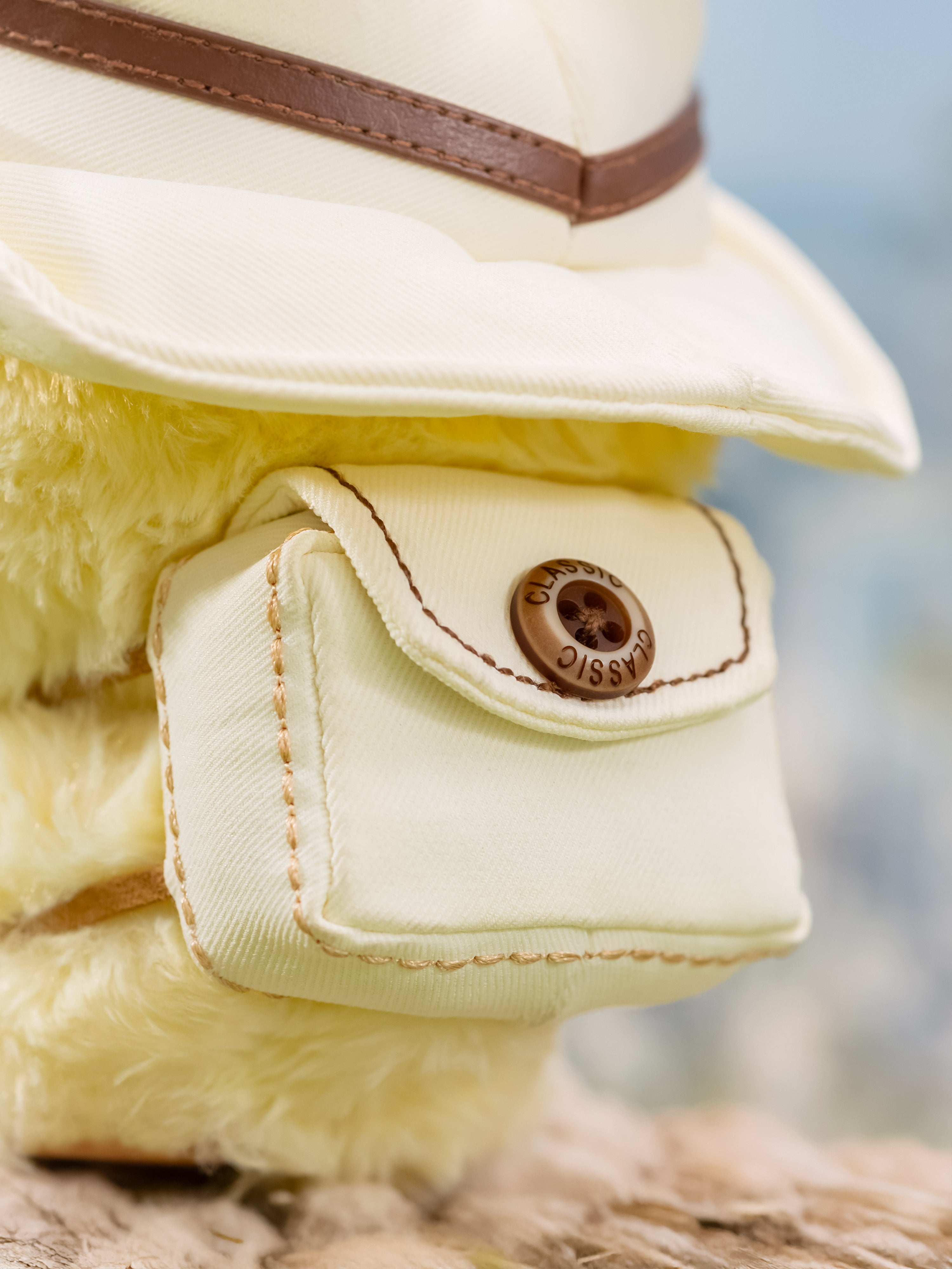Q. Kid Outdoor Activities Series PVC Plush Blind Box features a fluffy plush toy with a cream hat and pouch, showcasing intricate stitching and a CLASSIC button.