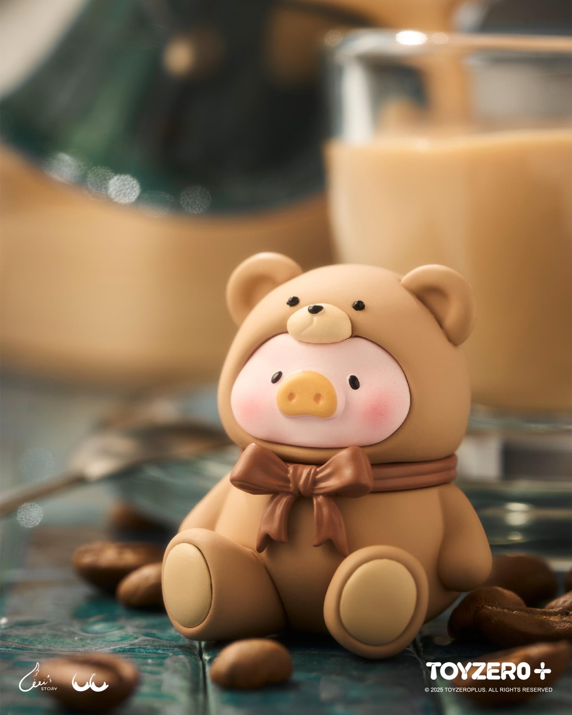 LuLu the Piggy - Teddy MINI Limited Edition (Milk Tea Festa) figure in a bear onesie, posed on coffee beans with a blurred coffee mug backdrop.