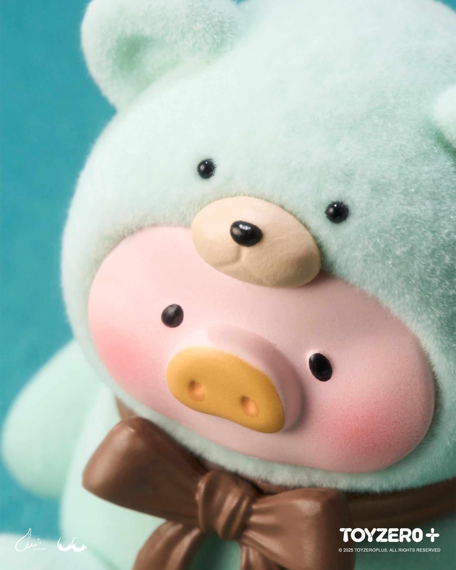 LuLu the Piggy - Teddy MINI Limited Edition features a mint-green, fuzzy head with black eyes, pink cheeks, a yellow snout, and a brown bow.