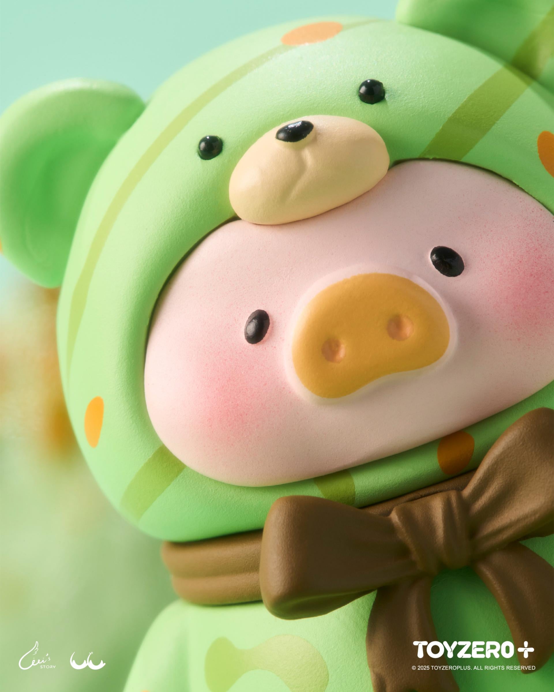 LuLu the Piggy - Teddy MINI Limited Edition (Summer Chill), a designer toy in a green hooded onesie, featuring a stylized pig face and brown bow.