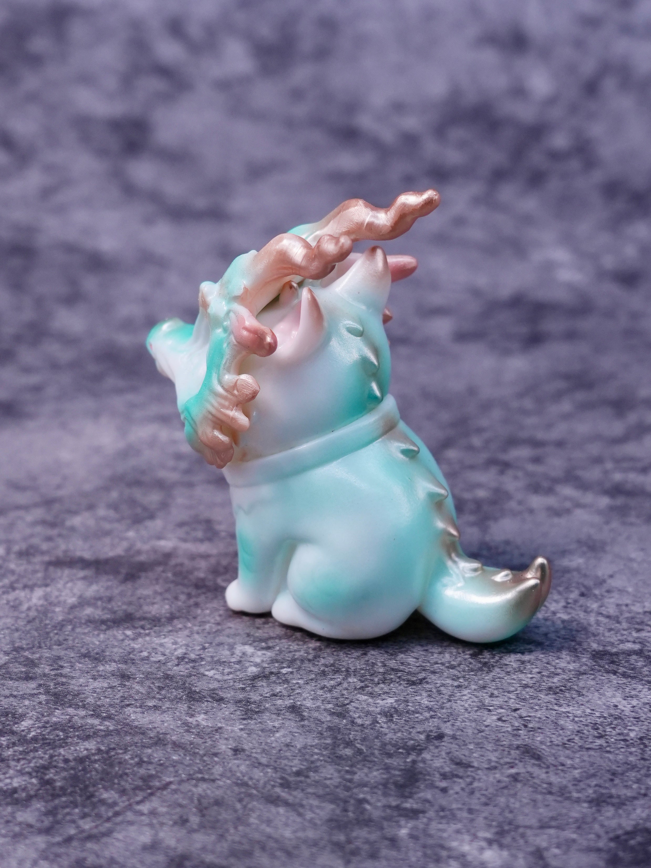 Little Azure Loong by HOTRU, a pearlescent figurine with antler-like horns, rotatable head, and a removable dragon bone mask, embodies playful artistry.
