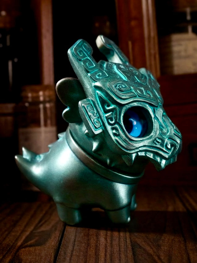 Little Bronze Taotie figurine with teal-green finish, glossy blue eye, and rotatable head, showcasing abstract patterns, by HOTRU—preorder from Strangecat Toys.
