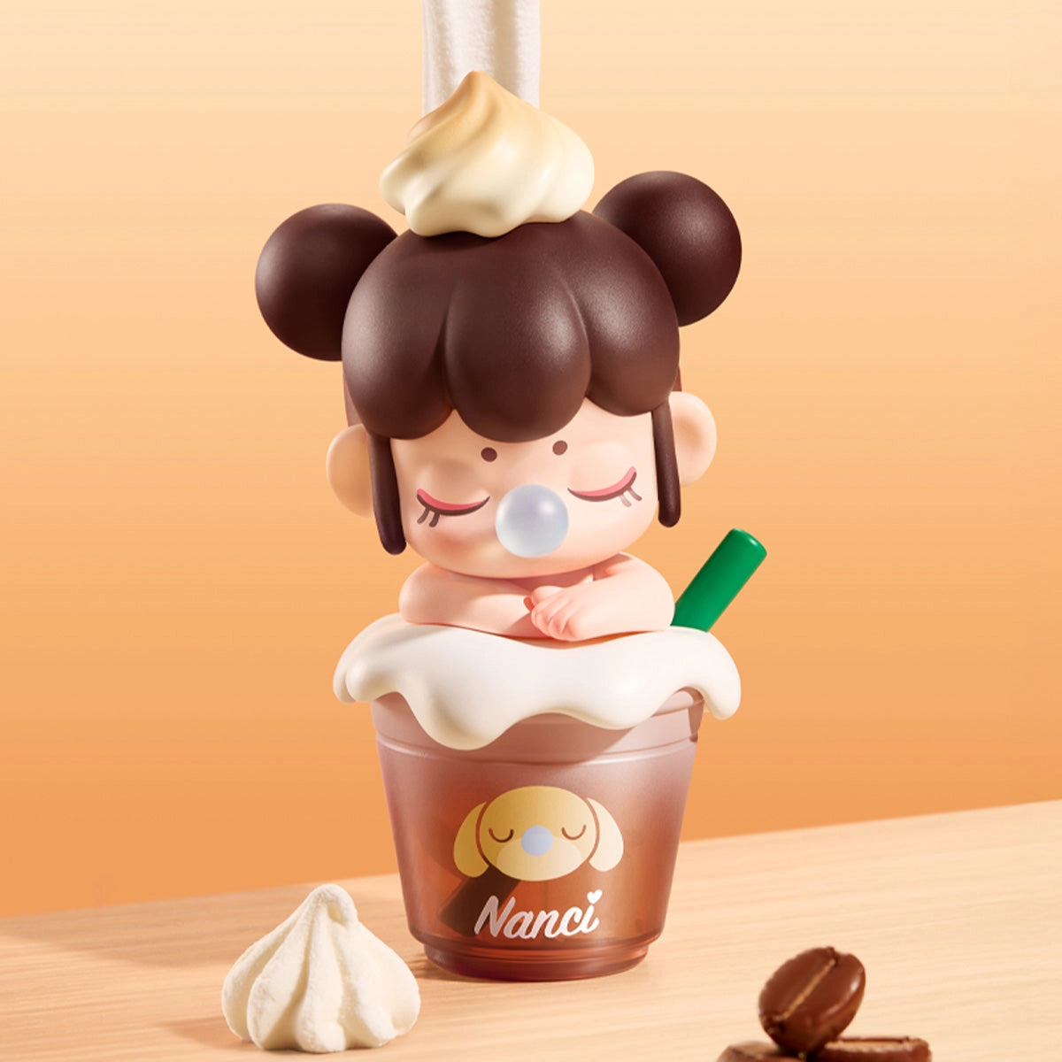 Rolife BabyNanci Surprise Figure Doll in a milk tea cup with whipped cream, bubble gum, and a sleepy dog face design, next to a meringue and coffee beans.