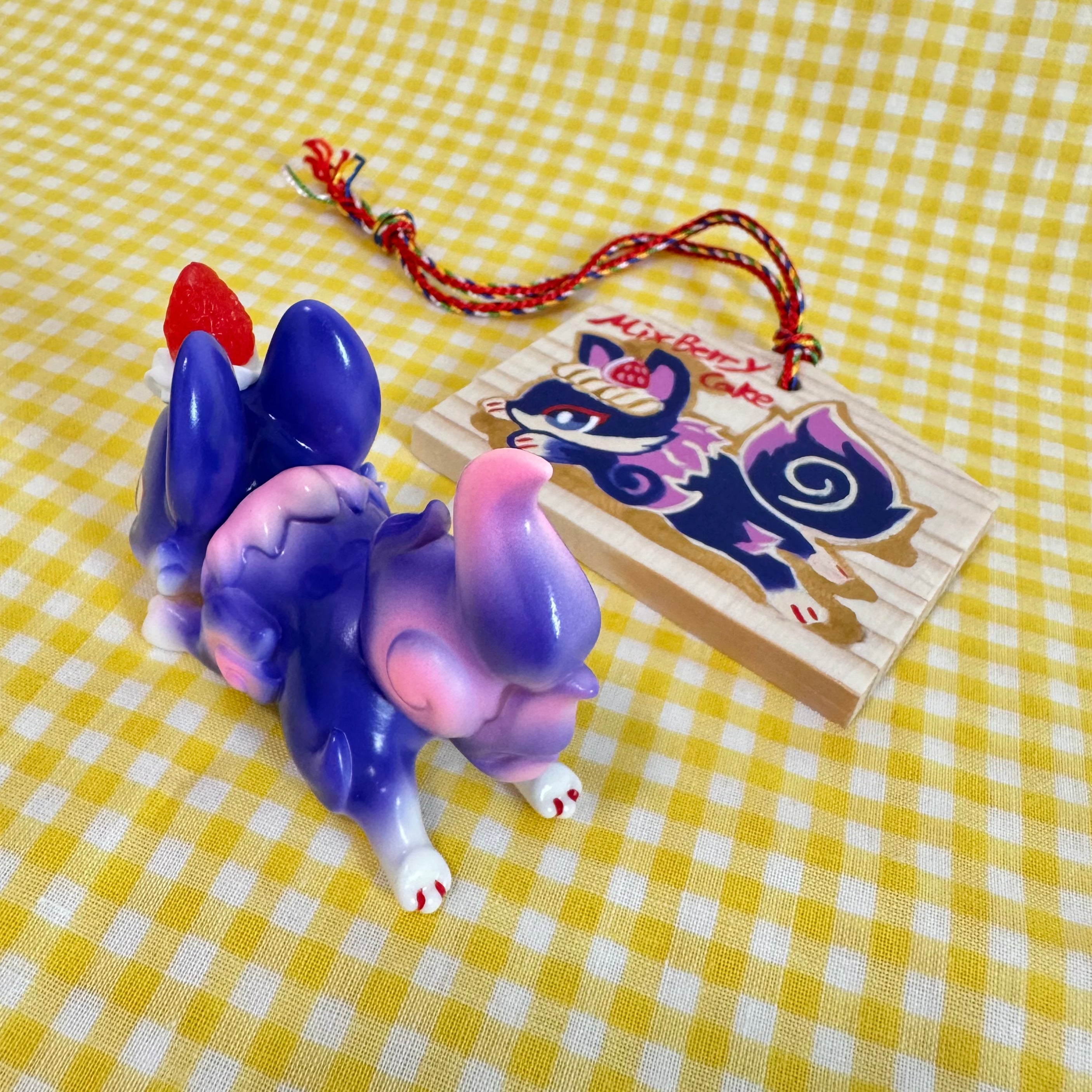 Alt text: Little Sleeping Fox - Mixed Berry Cheesecake by Genkosha, a ~6cm soft vinyl toy animal, displayed on a table.