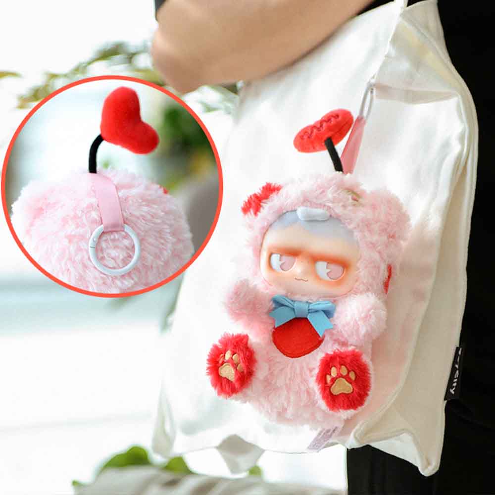 MONBOO-Monster Paradise Series Plush Blind Box features a fluffy pink character pouch clipped to a simple canvas tote, available for preorder.